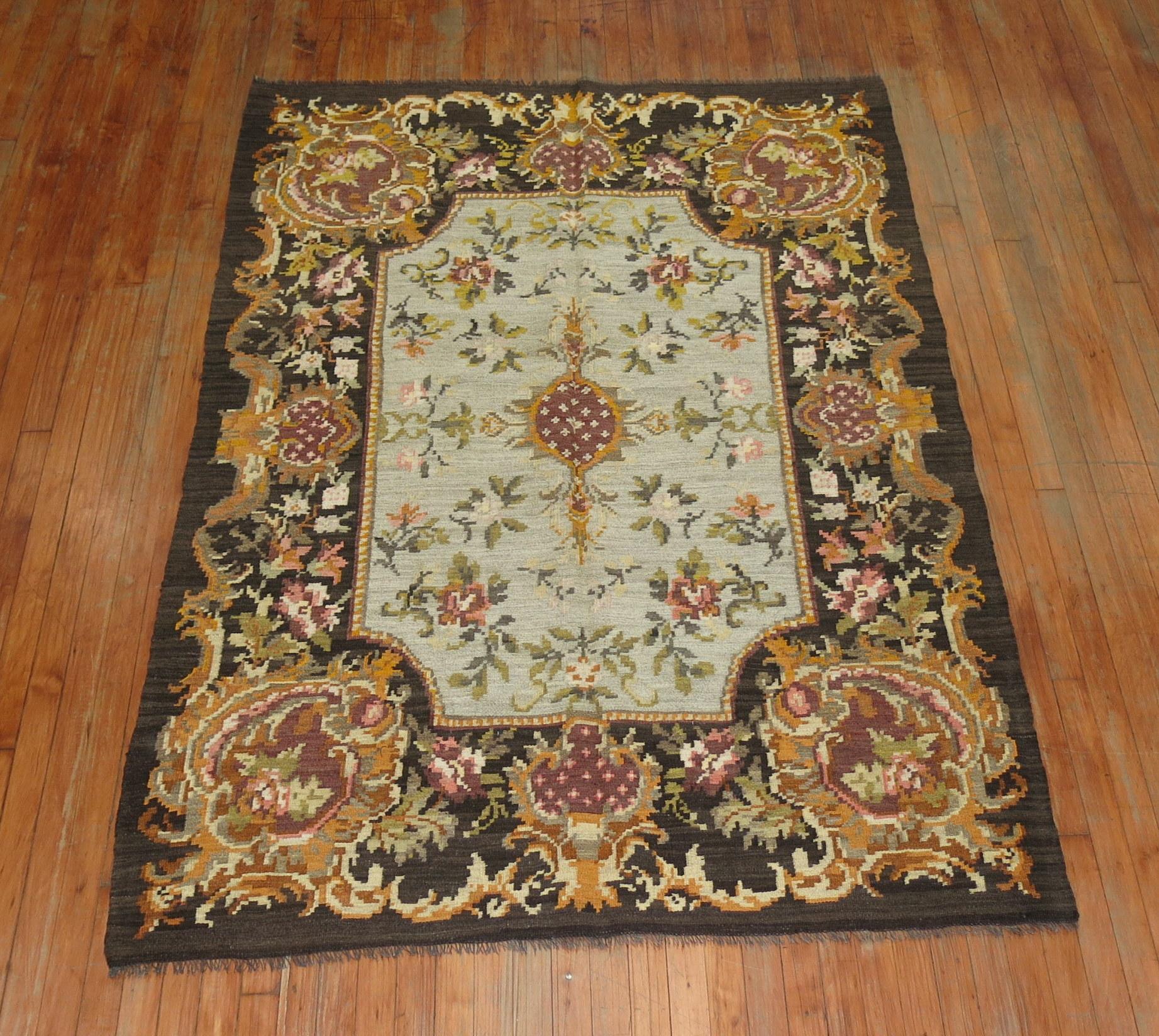 A midcentury intermediate-size Besserabian Kilim with floral elements throughout.

5' x 7'6''