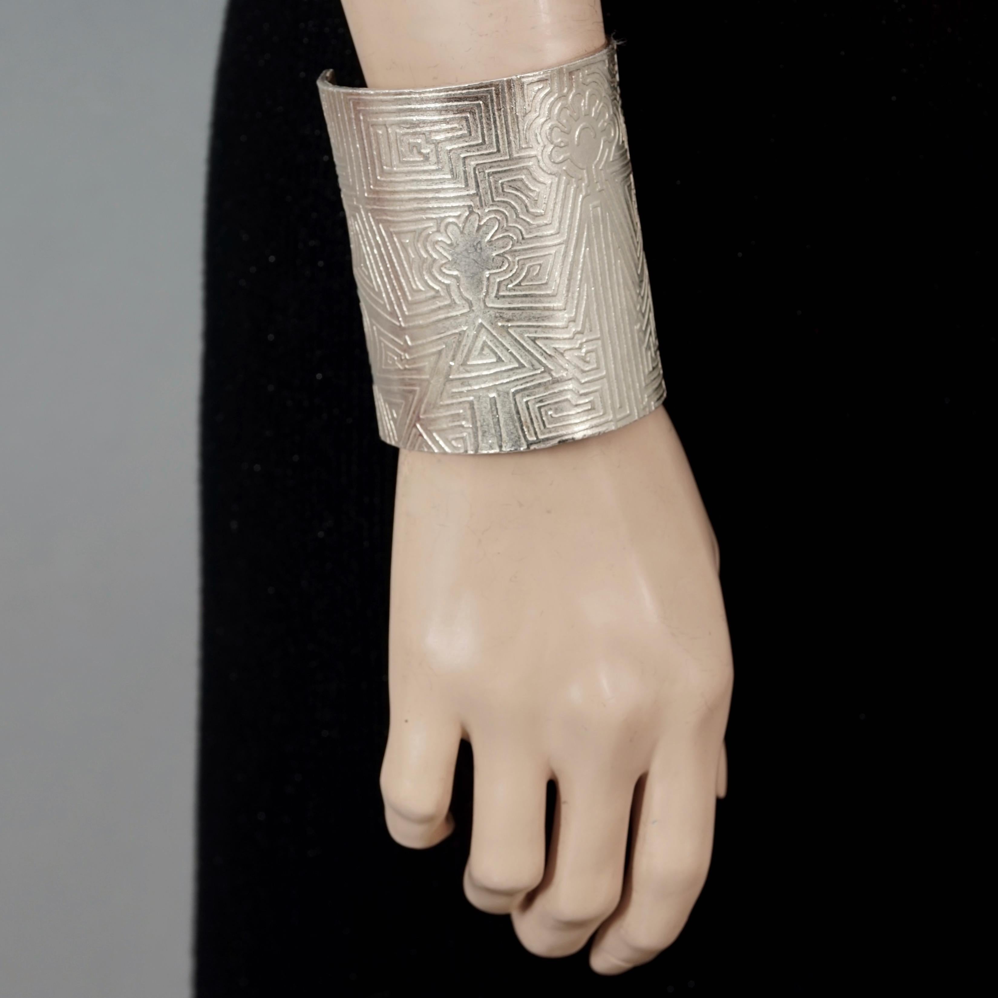 Vintage BICHE de BERE Figural Geometric Wide Silver Cuff Bracelet

Measurements:
Height: 3.46 inches (8.8 cm)
Length: 7.08 inches (18 cm) opening included

Features:
- 100% authentic BICHE DE BERE.
- Wide embossed figural geometric patterned cuff