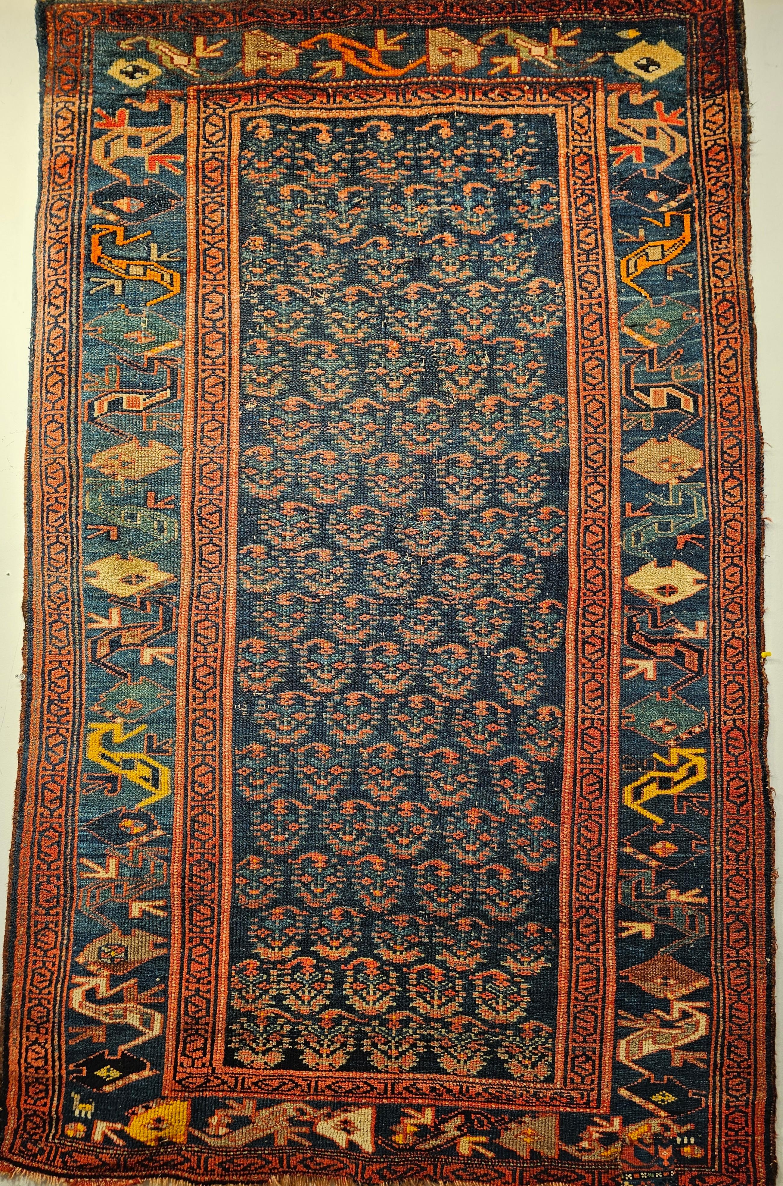 Vintage Persian Bidjar area rug in an allover paisley pattern in abrash navy blue, green, and saffron yellow colors circa the 4th quarter of the 1800s.  This beautiful rug was woven by the Kurds in the Western Persian Bidjar area.  It has an abrash