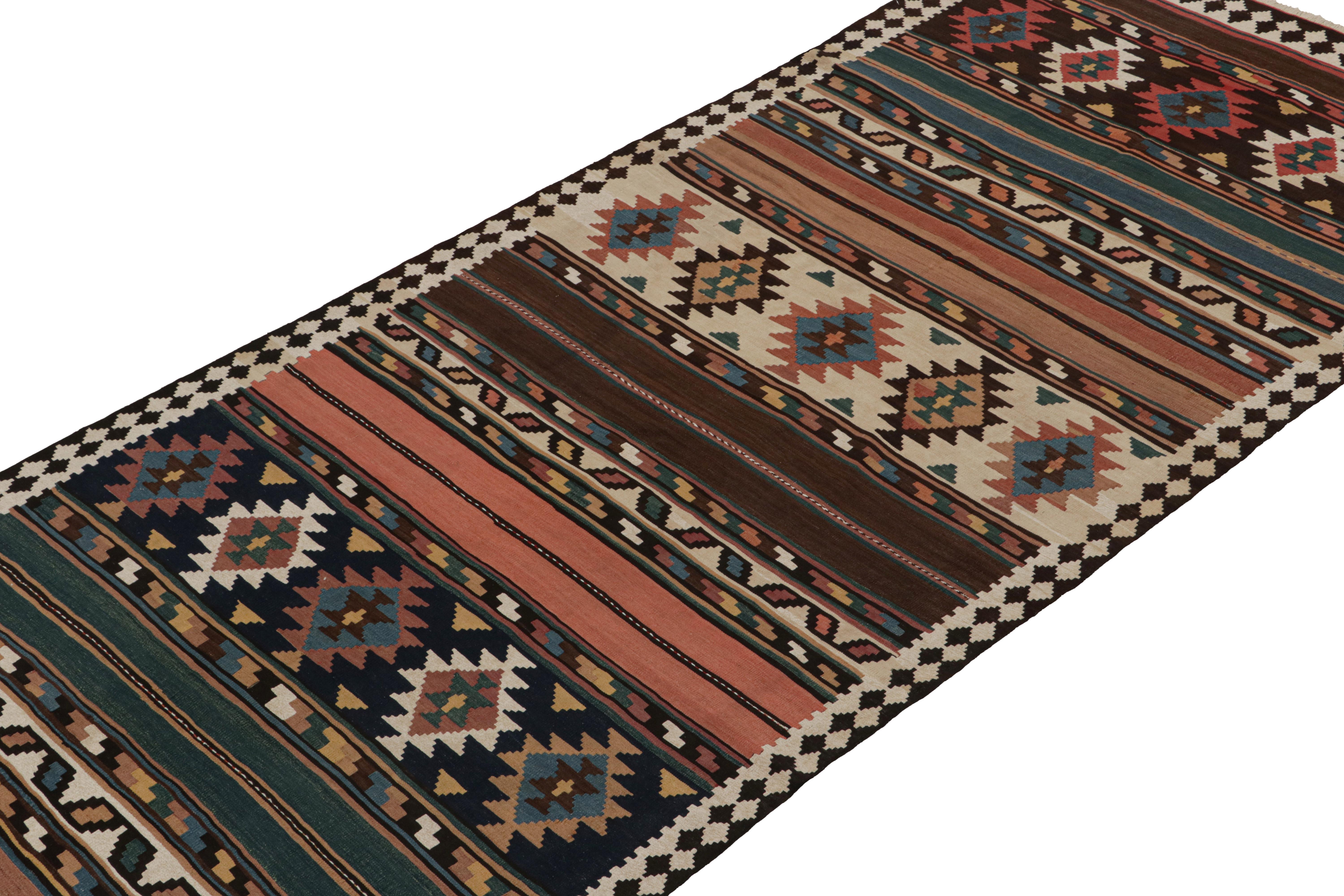 This vintage 5x11 Persian Kilim is believed to be a Bidjar tribal rug, handwoven in wool circa 1950-1960. 

On the Design:

Its design favors a complementary play of traditional geometric patterns & stripes in rich colors. Keen eyes will note an