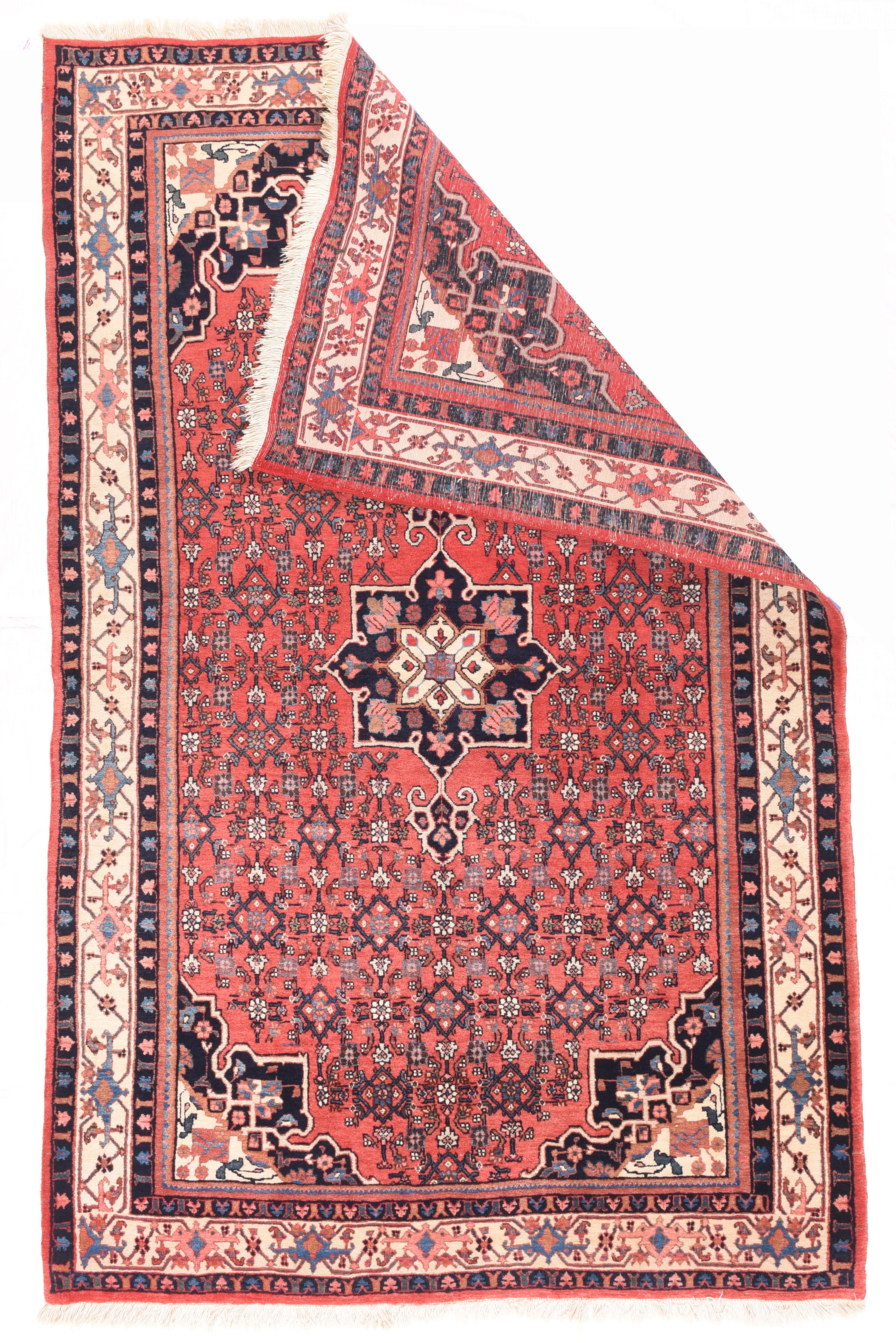 Vintage Bidjar Rug 4'11'' x 8'3''. This is a semi-fine Kurdish city scatter with a type reputation for eternal durability as well as looking pretty good. A small navy octogramme medallion hosts a smaller conforming ivory sub-medallion, With semi-en