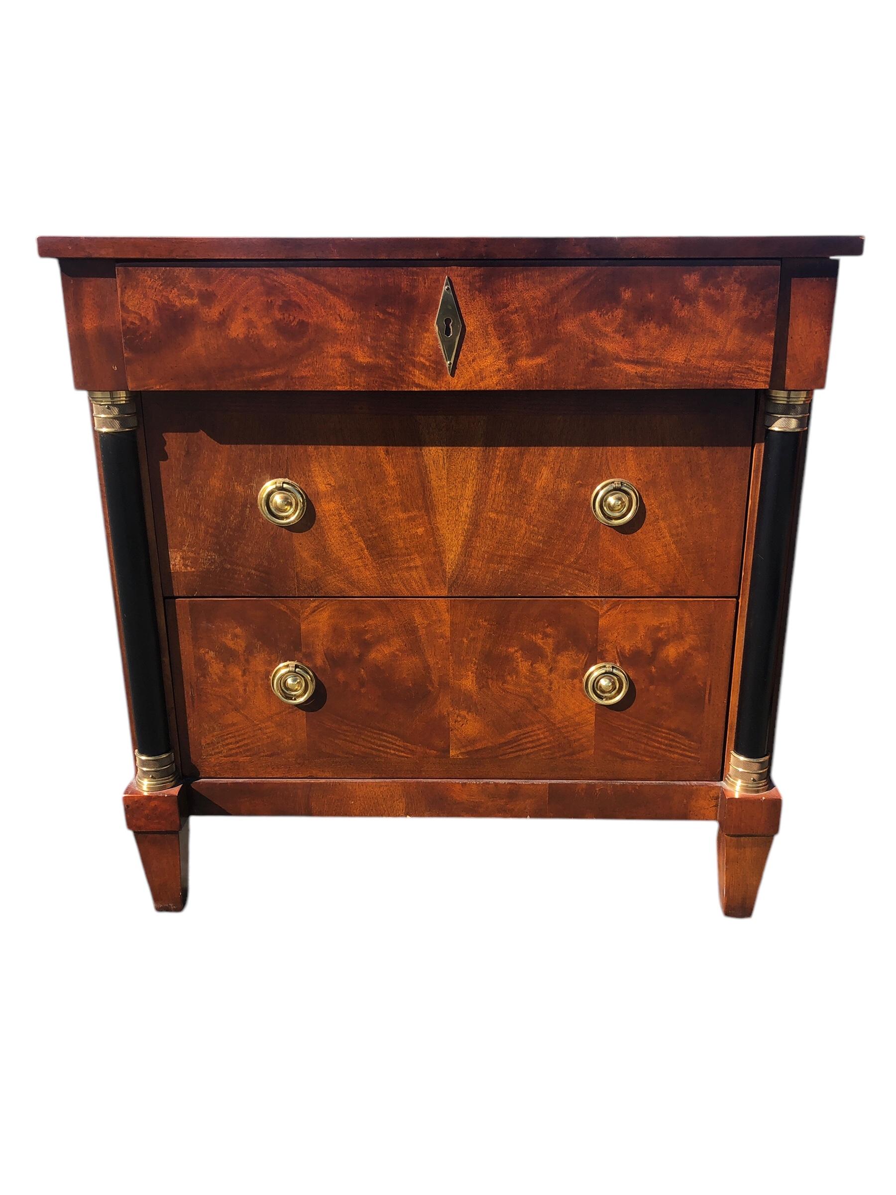 Vintage Neoclassical Capuan Dresser by Century Furniture. Designed by Ray Sabota, Biedermeier stylings are evident in the lovely mahogany veneers  Two ebonized columns flank the three drawers and are raised on square tapered legs. The top board is