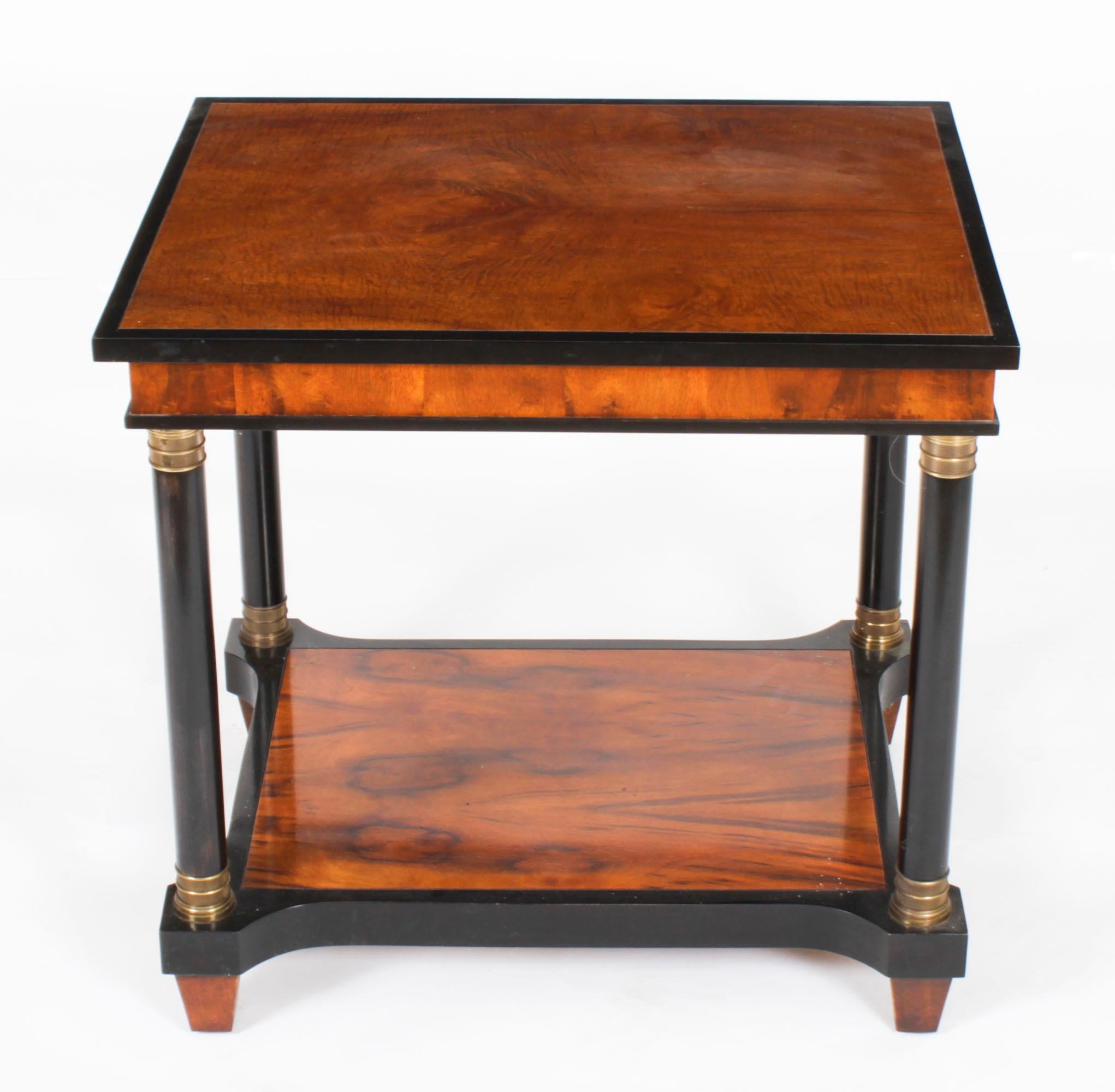 This is a stylish vintage Biedermeier walnut and ebonised occasional table retailed by Harrods, circa 1980 in date.
 
The rectangular table features beautiful walnut throughout with ebonised banding and ormolu mounted Doric column legs united by a