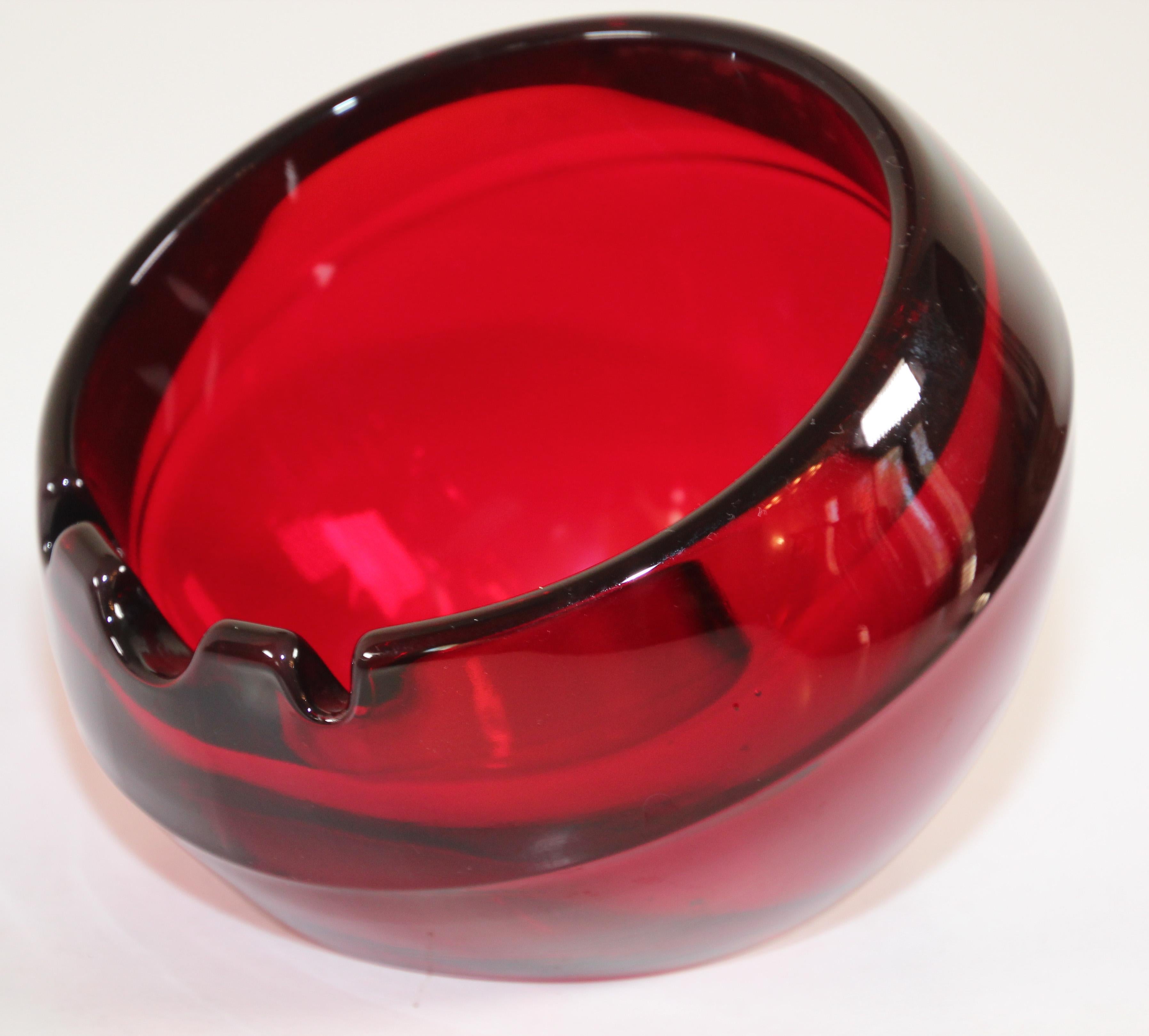 Big ashtray orb in ruby by Viking Art Glass.
Beautiful, thick, deep ruby red heavy thick glass ashtray is shaped like an open sphere with a flat bottom.
Ashtray orb designed and made in the mid-20th century.
Designed and made in the mid-20th century