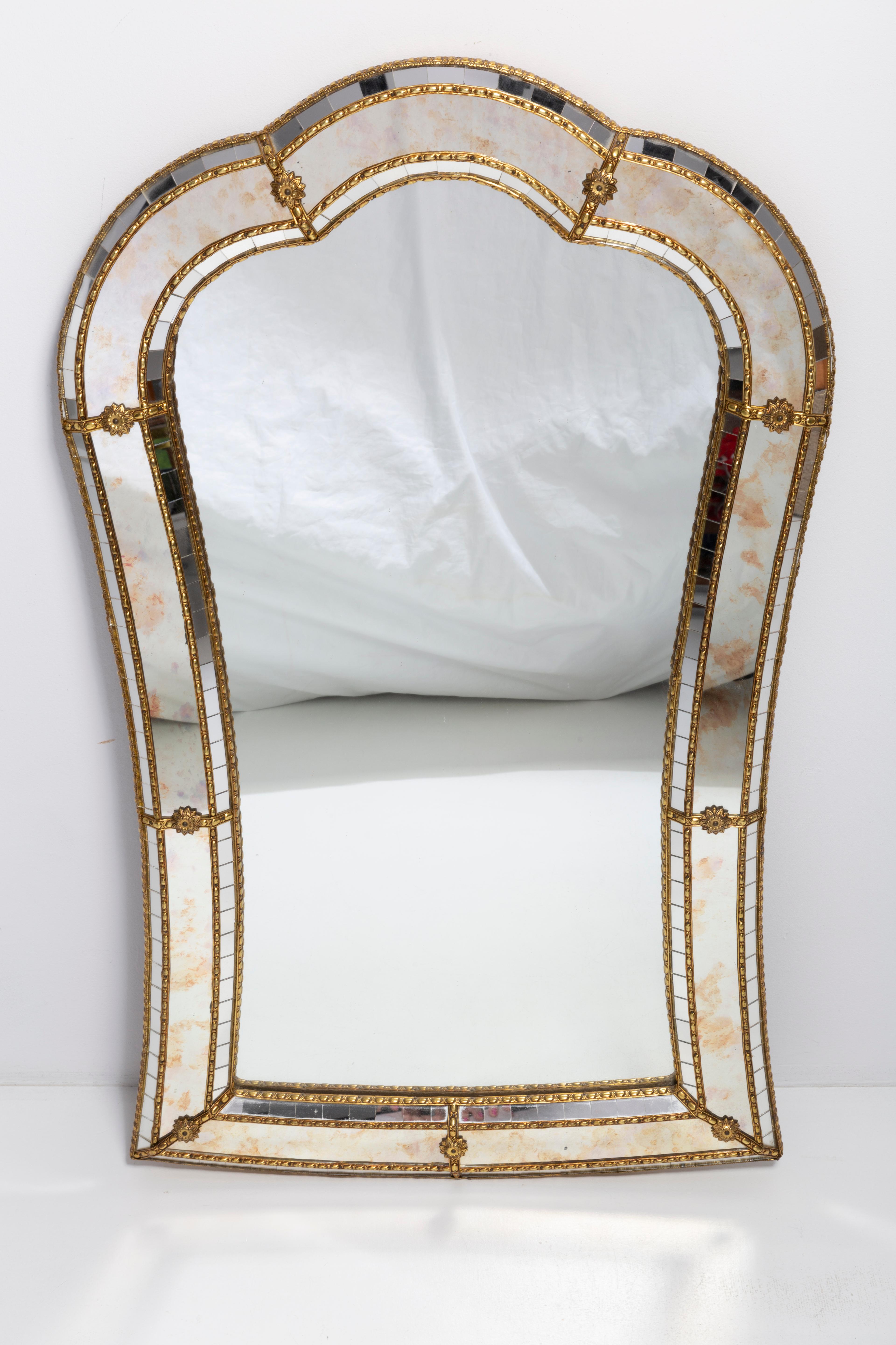 A beautiful medium size mirror in a golden decorative frame from Italy. Looks absolutely fantastic! The frame is made of metal. Mirror is in very good vintage condition, no damage or cracks in the frame. Original glass. Beautiful piece for every