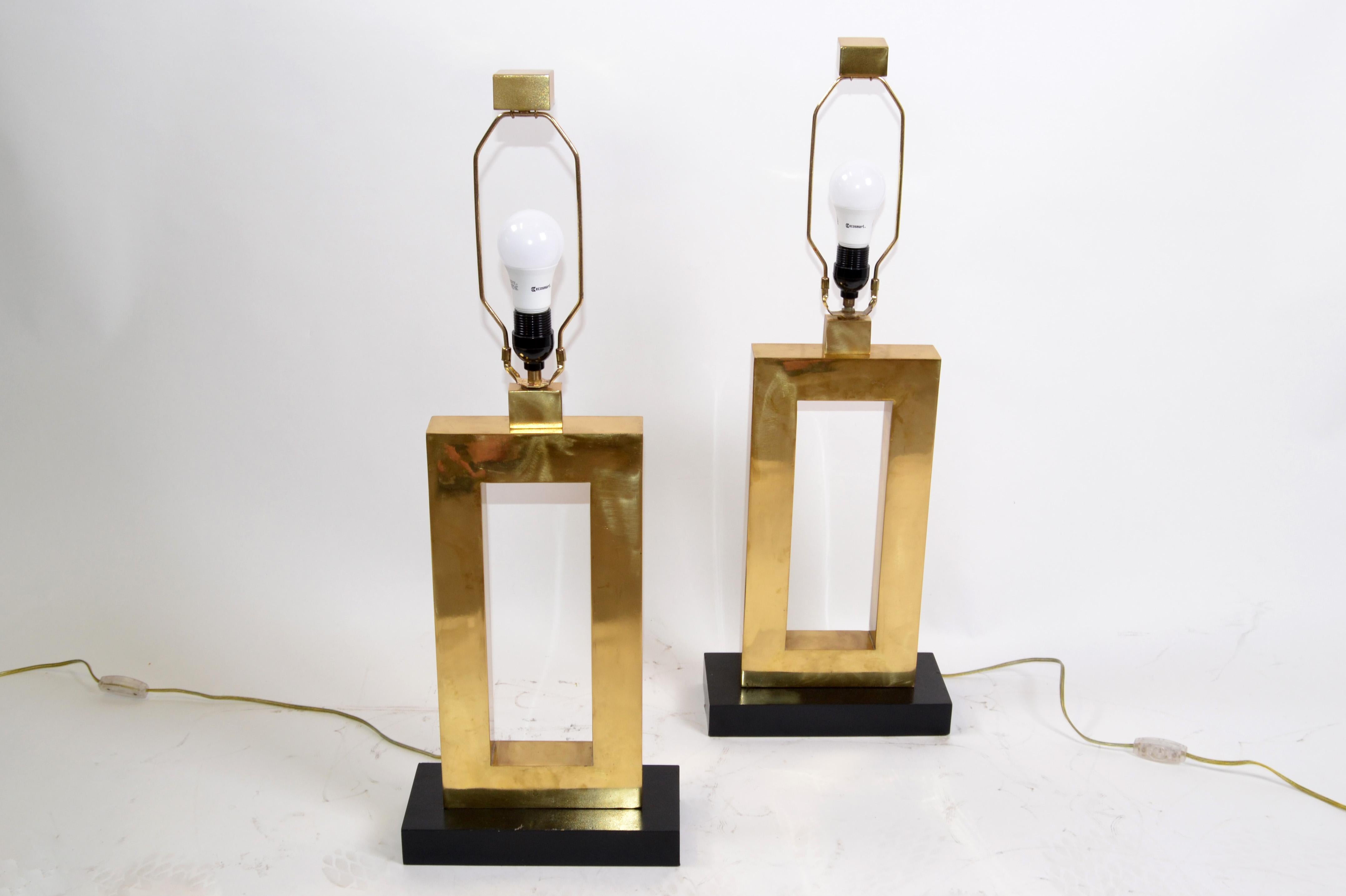 A pair of Mid-Century Modern big scale brass and ebonized wood rectangular solid brass table lamps.
The Pair comes with Harps, matching finials and is heavy.
In perfect working condition and each uses a max. 60 watts light bulb.
They have a