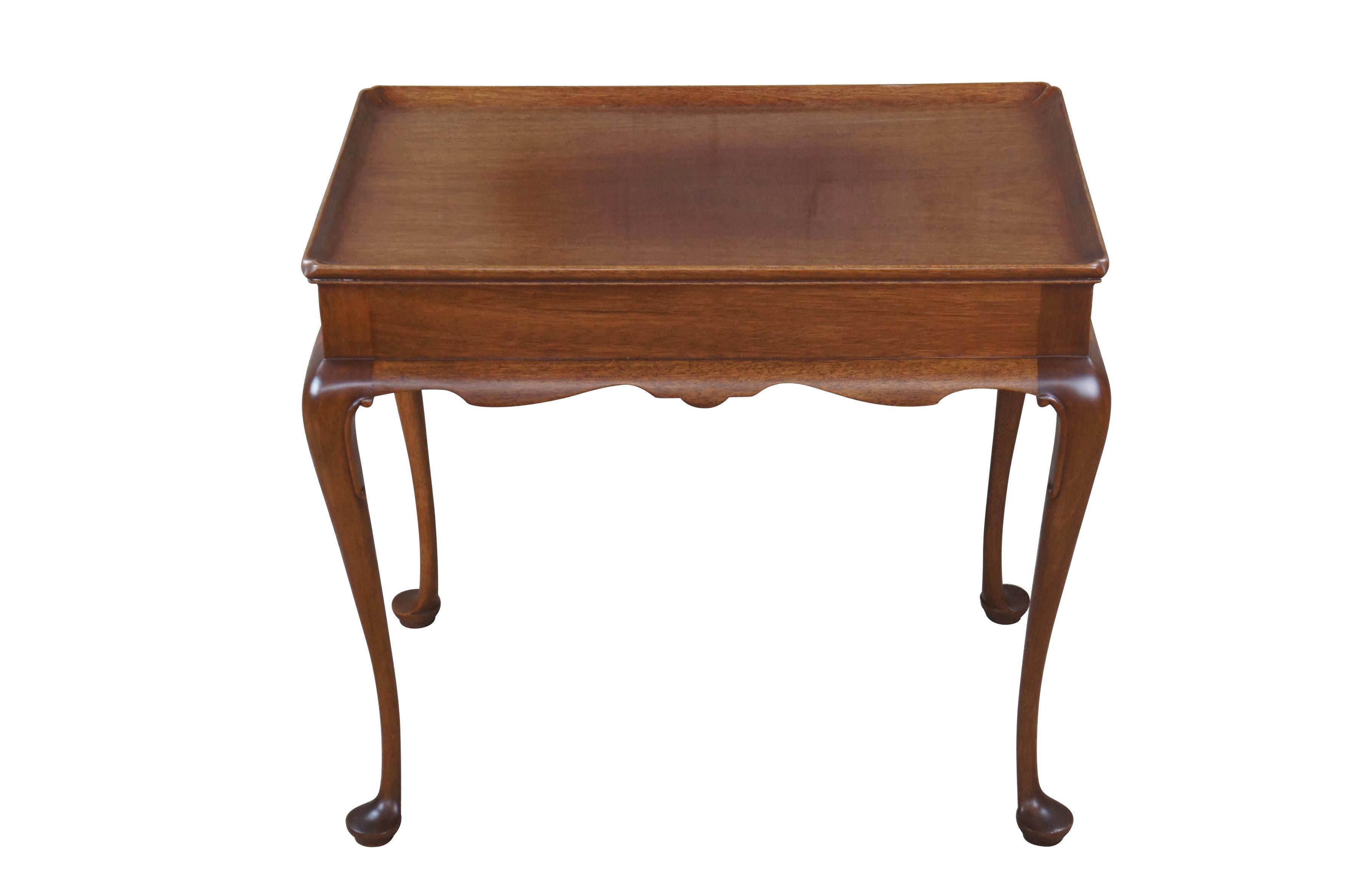 Biggs Furniture Queen Anne style tea table, circa last half 20th century. Made from mahogany with an inset top, serpentine scalloped skirt and cabriole legs leading paw feet. Originally Purchased from William W. Sauer Associates Ltd. Virginia Beach,