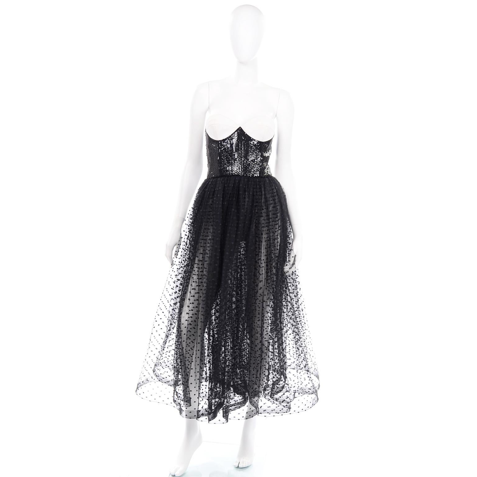 This is a dramatic vintage Bill Blass dress with a fitted bustier style bodice that is covered in black sequins up to the white cotton bra cups. The full skirt has heavy pleating, creating the illusion of a double layered skirt. The white ribbed