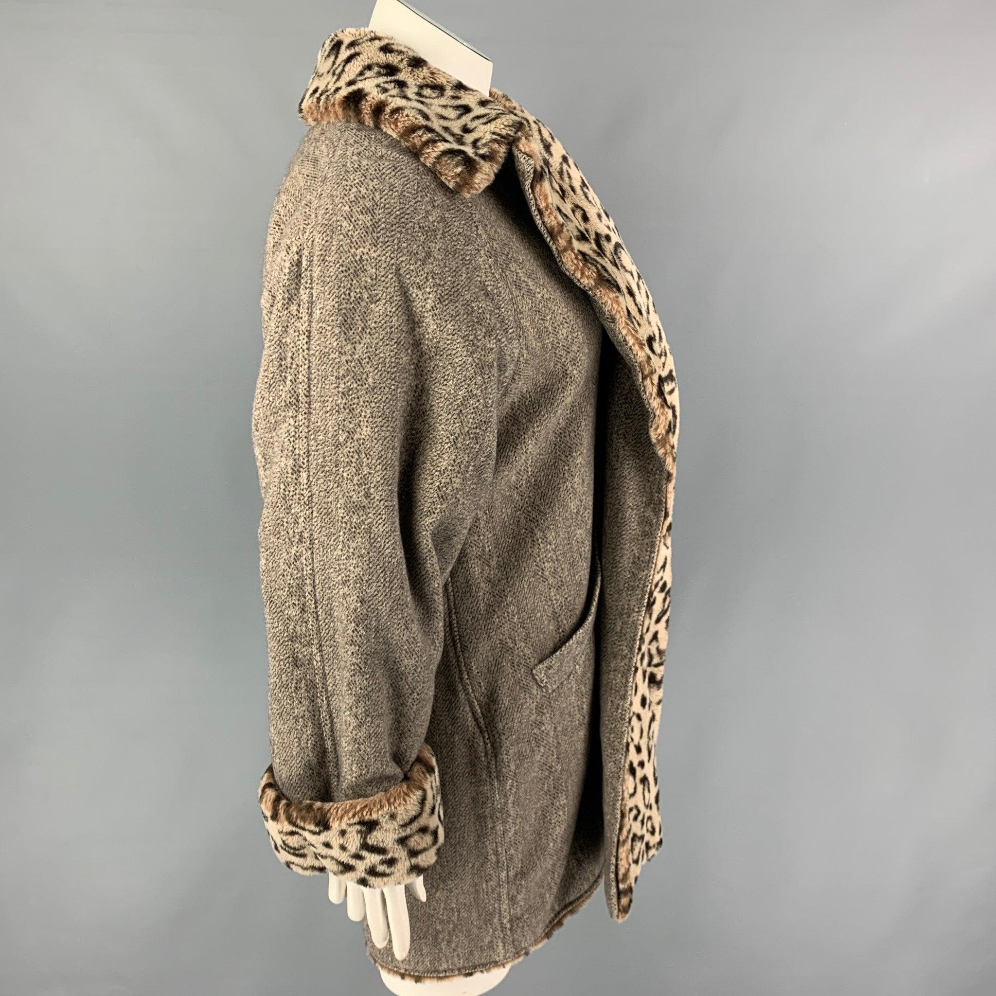 Vintage BILL BLASS coat comes in a grey & brown animal print faux fur featuring a large lapel, front pockets, and a hook & loop closure.
Good
Pre-Owned Condition. Fabric tag removed.  

Marked:   Size tag removed.  

Measurements: 
 
Shoulder: 21