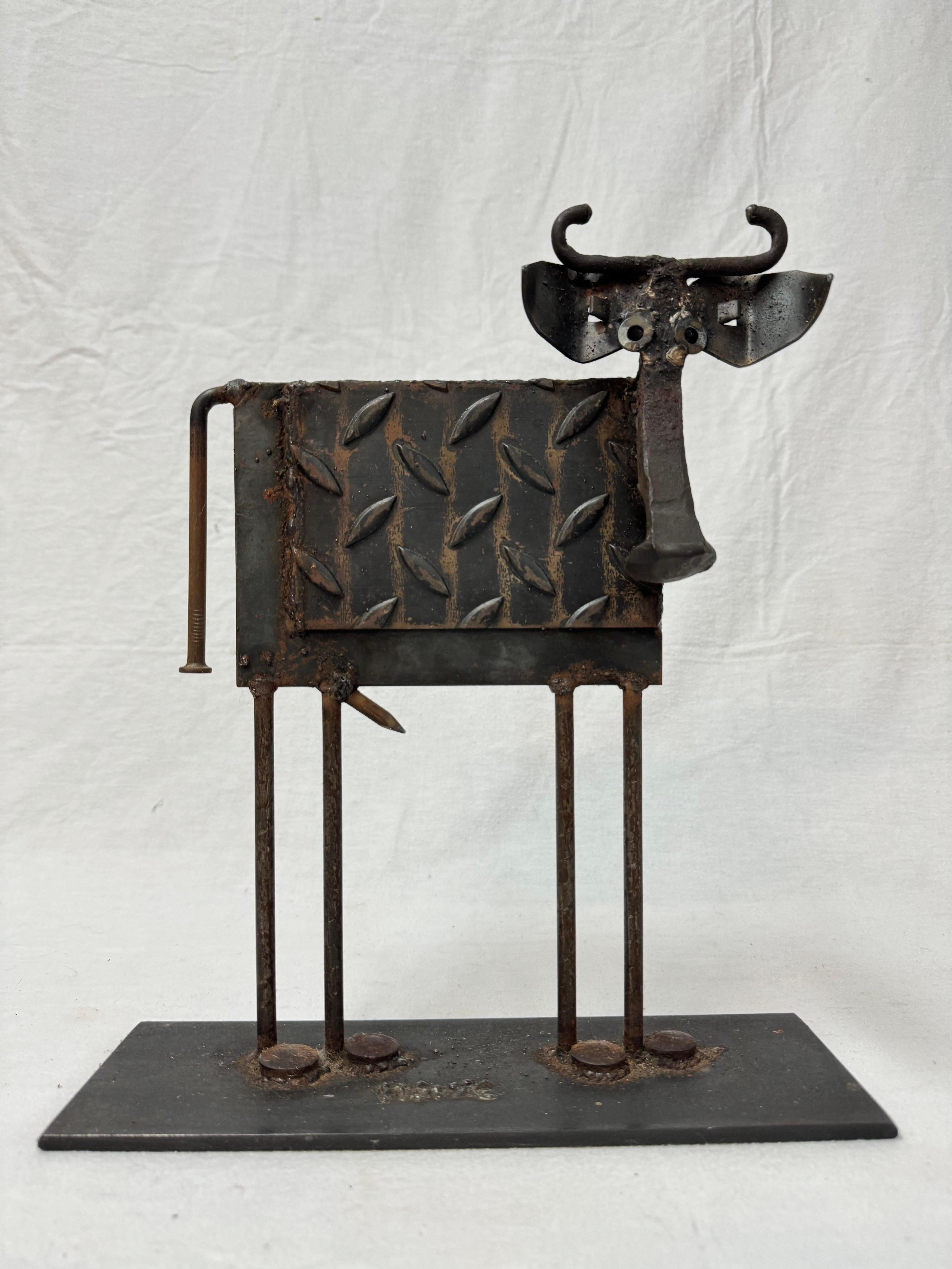 Whimsical Steampunk brutalist  sculpture or door stop  of a cow by Bill Heise, American (1943-2011). Iron and mixed metal cow sculpture, signed 