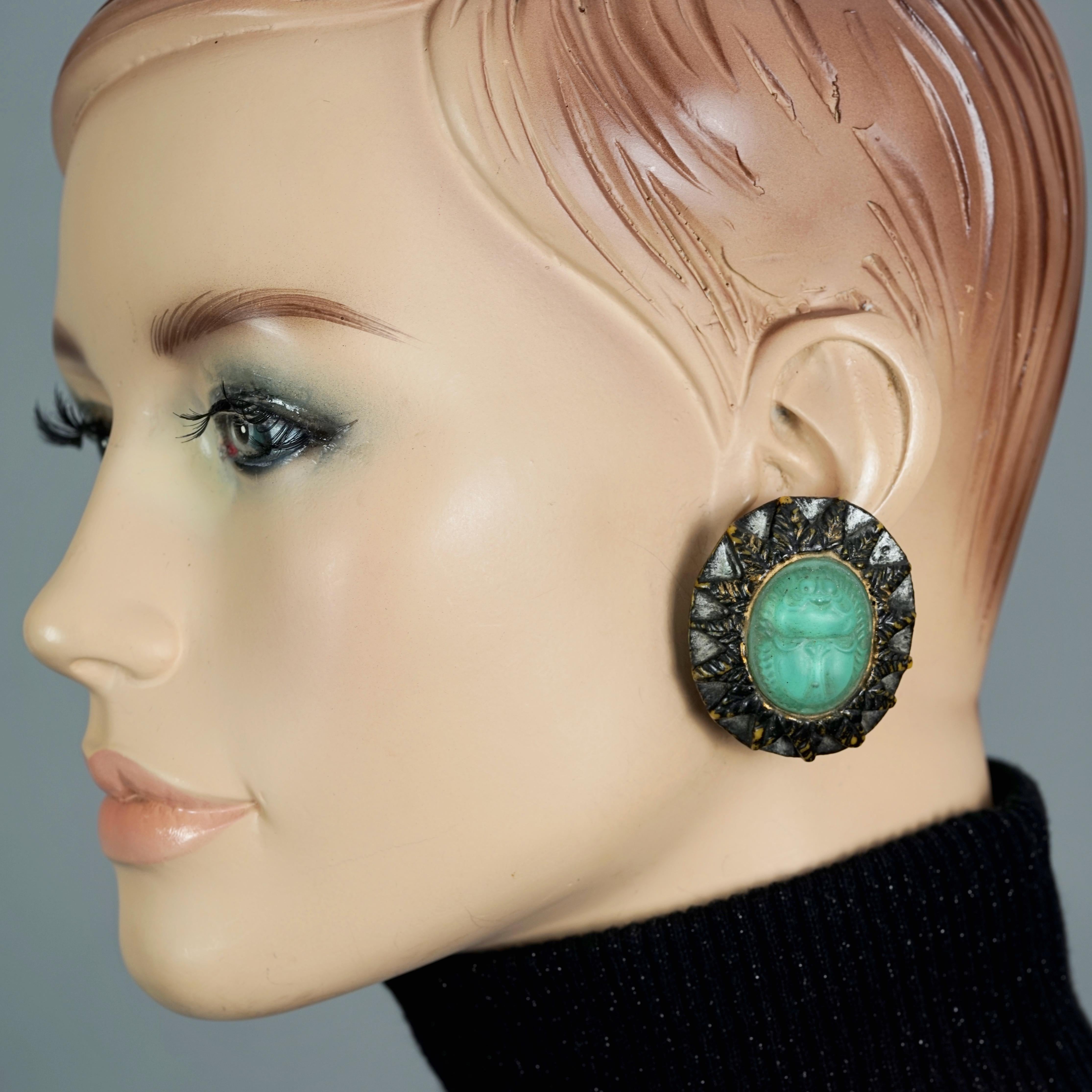 Vintage BILLY BOY SURREAL Bijoux Egyptian Revival Scarab Earrings

Measurements:
Height: 1.73 inches (4.4 cm)
Width: 1.53 inches (3.9 cm)
Weight per Earring: 14 grams

Features:
- 100% Authentic BILLY BOY SURREAL BIJOUX.
- Egyptian Revival scarab on