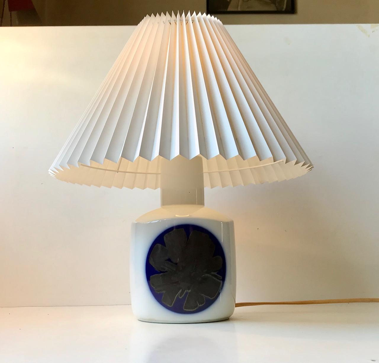 White glazed porcelain table light with an abstract center motif in blue and slate-black glazes. Designed in-house at Bing & Grondahl in Denmark during the 1960s. This one dates from the 70s. The shade is a model shade and is not included.