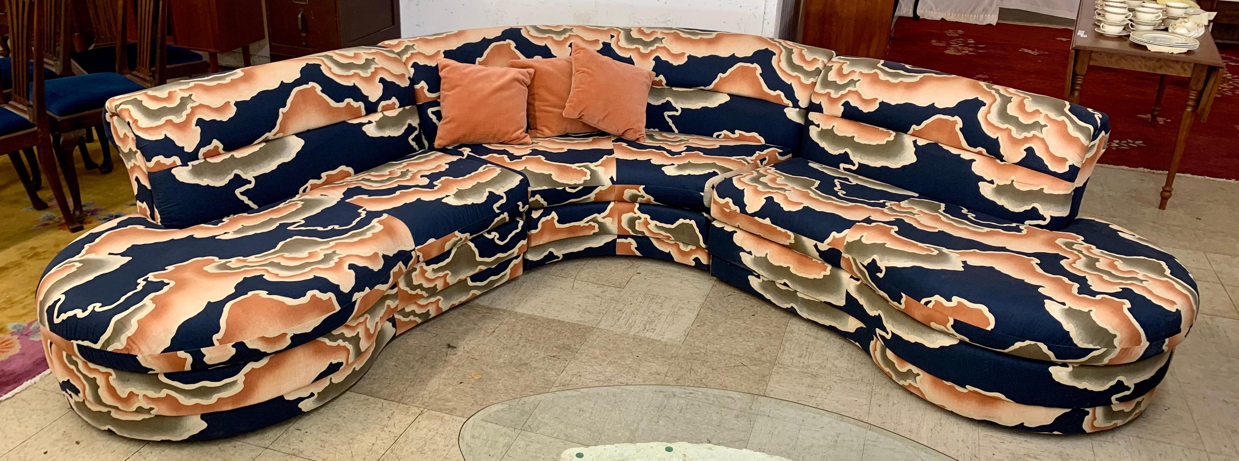 Colorful groovy biomorphic vintage 3 pc curved sectional sofa upholstered in a navy, orange and olive green print fabric. Original fabric in excellent condition. Super comfortable.

Left piece measures 57 inches wide x 39 inches deep x