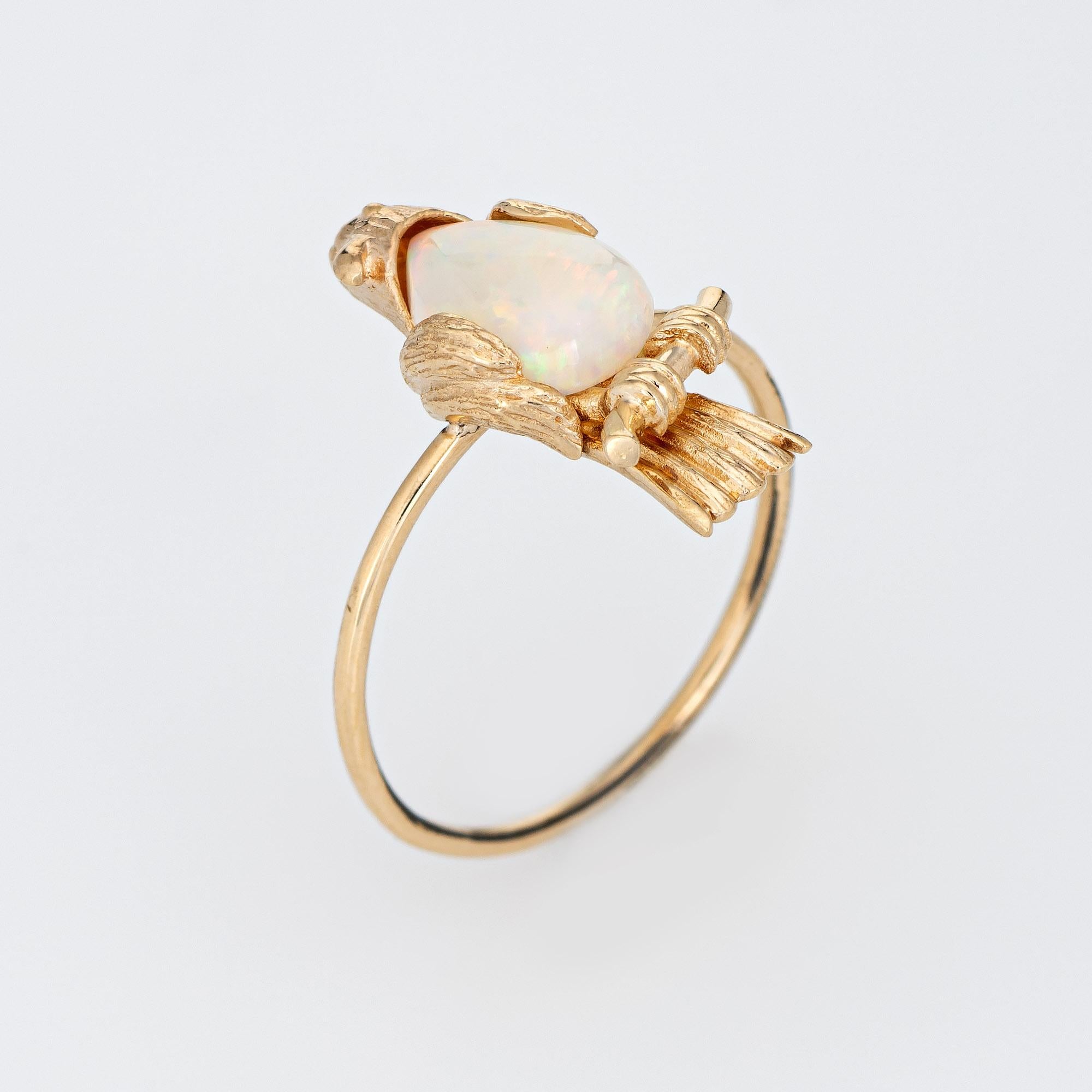 Originally a vintage stick pin (circa 1950s to 1960s), the bird is crafted in 14 karat yellow gold.

The ring is mounted with the original stick pin. Our jeweler rounded the stick pin into a slim band for the finger. The beautifully detailed bird