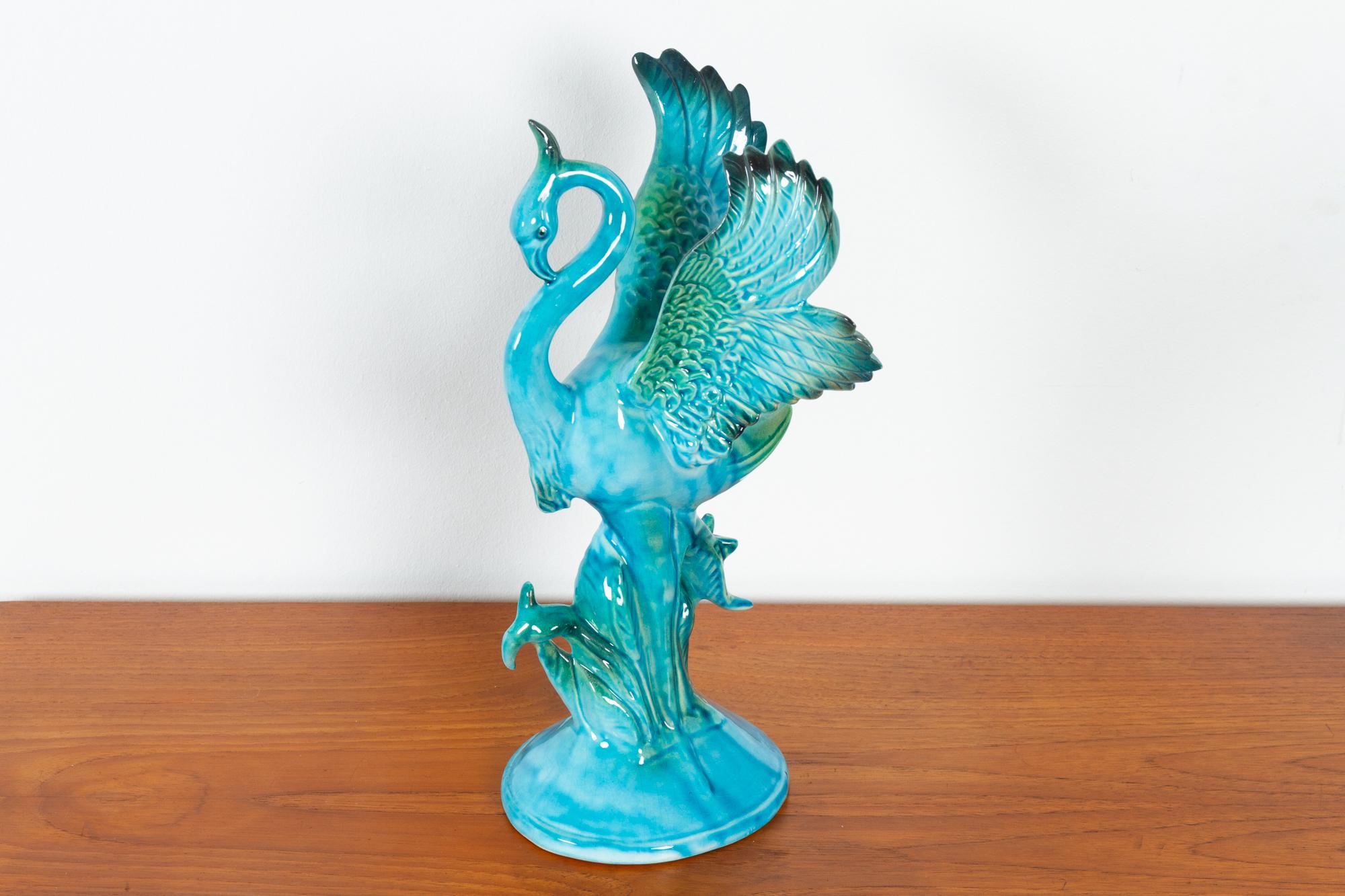 Vintage bird figurine by Jema Holland, 1960s
Porcelain figurine of a flamingo in stunning blue, green and turquoise glaze.
Measure: Height: 31 cm.
Good original condition with no damages.