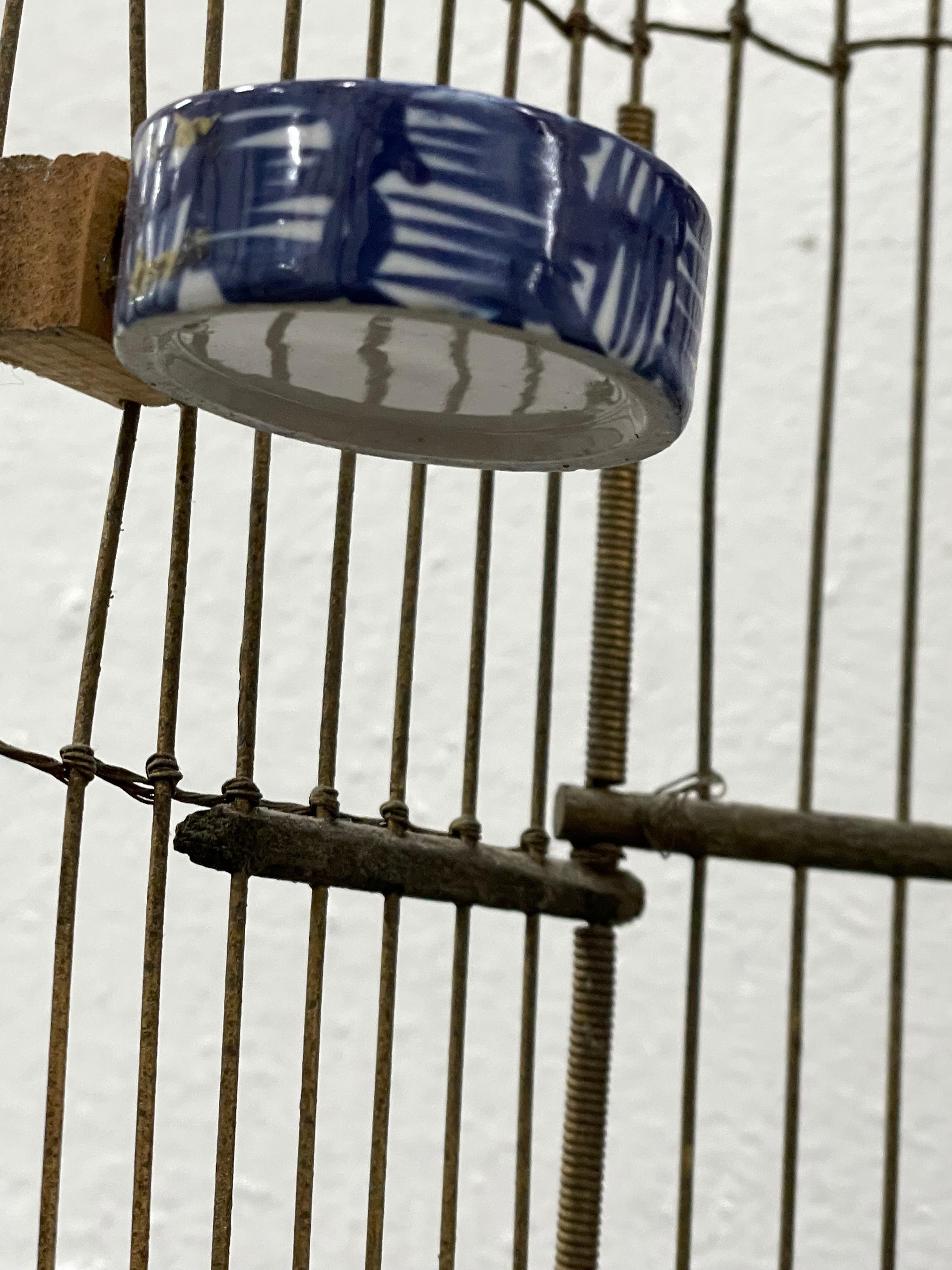 Vintage Birdcage W/ Blue & White Porcelain Feeders In Good Condition For Sale In San Francisco, CA