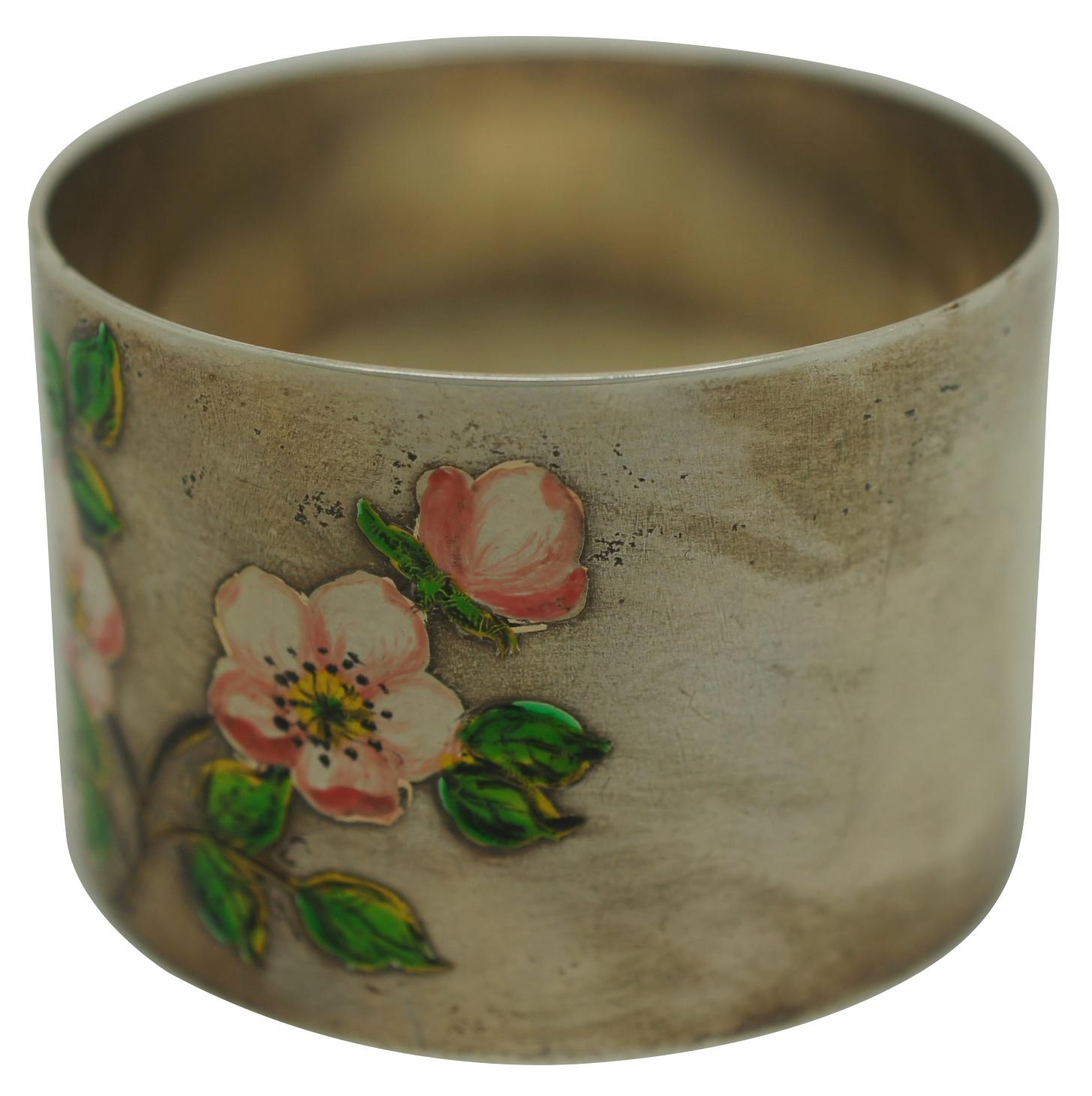 Vintage British sterling silver napkin ring circa 1960s-1970s decorated with enamel painted cherry blossoms and leaves. Marked with the Birmingham anchor, lion and a date letter V. Maker’s mark reads RII.

Measures: 1.75” x 1.25” (diameter x