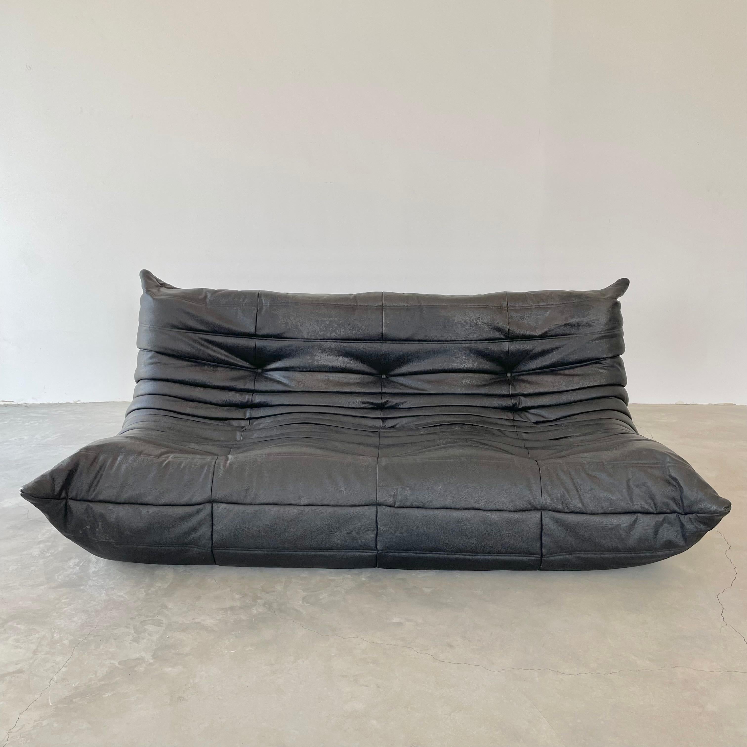 Classic French 3 seat Togo sofa by Michel Ducaroy for luxury brand Ligne Roset. Originally designed in the 1970s the iconic togo sofa is now a design classic. This sofa comes in its original vintage pebbled black leather.

Timeless comfort and