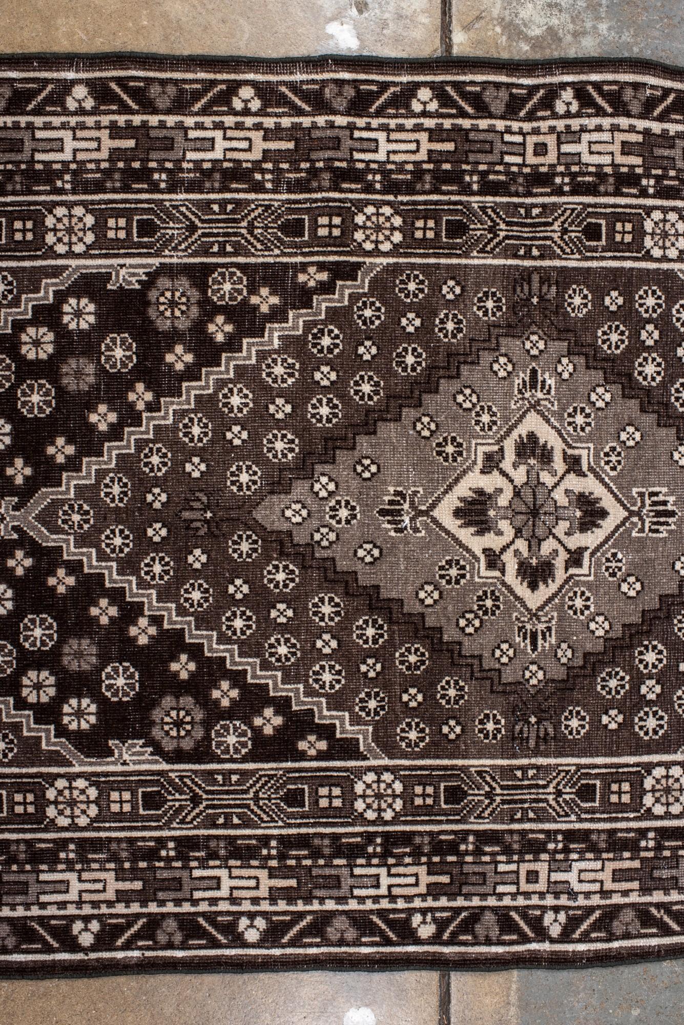 20th Century Vintage Black and Ivory Khotan Rug with Medallion and Floral Motif For Sale