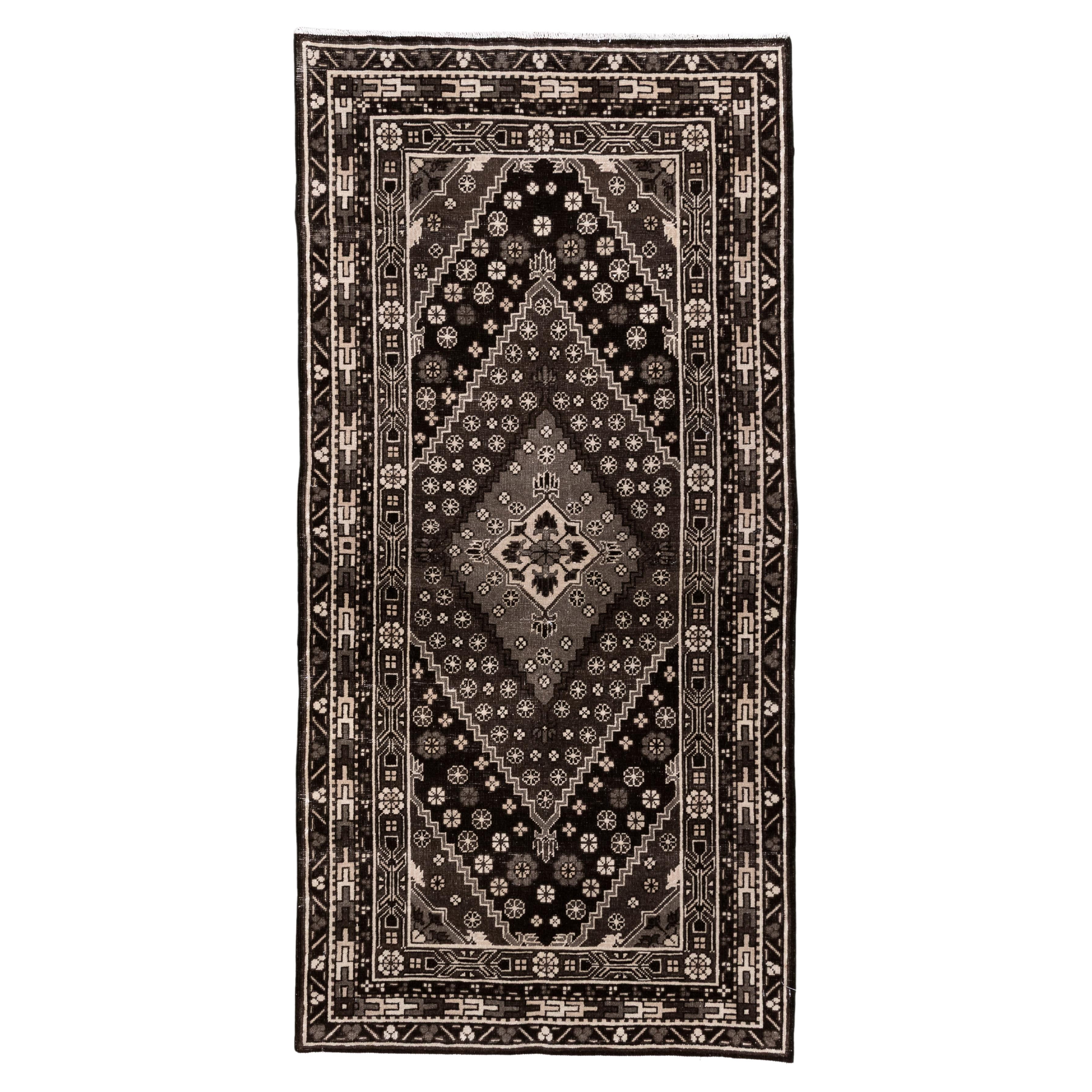 Vintage Black and Ivory Khotan Rug with Medallion and Floral Motif For Sale