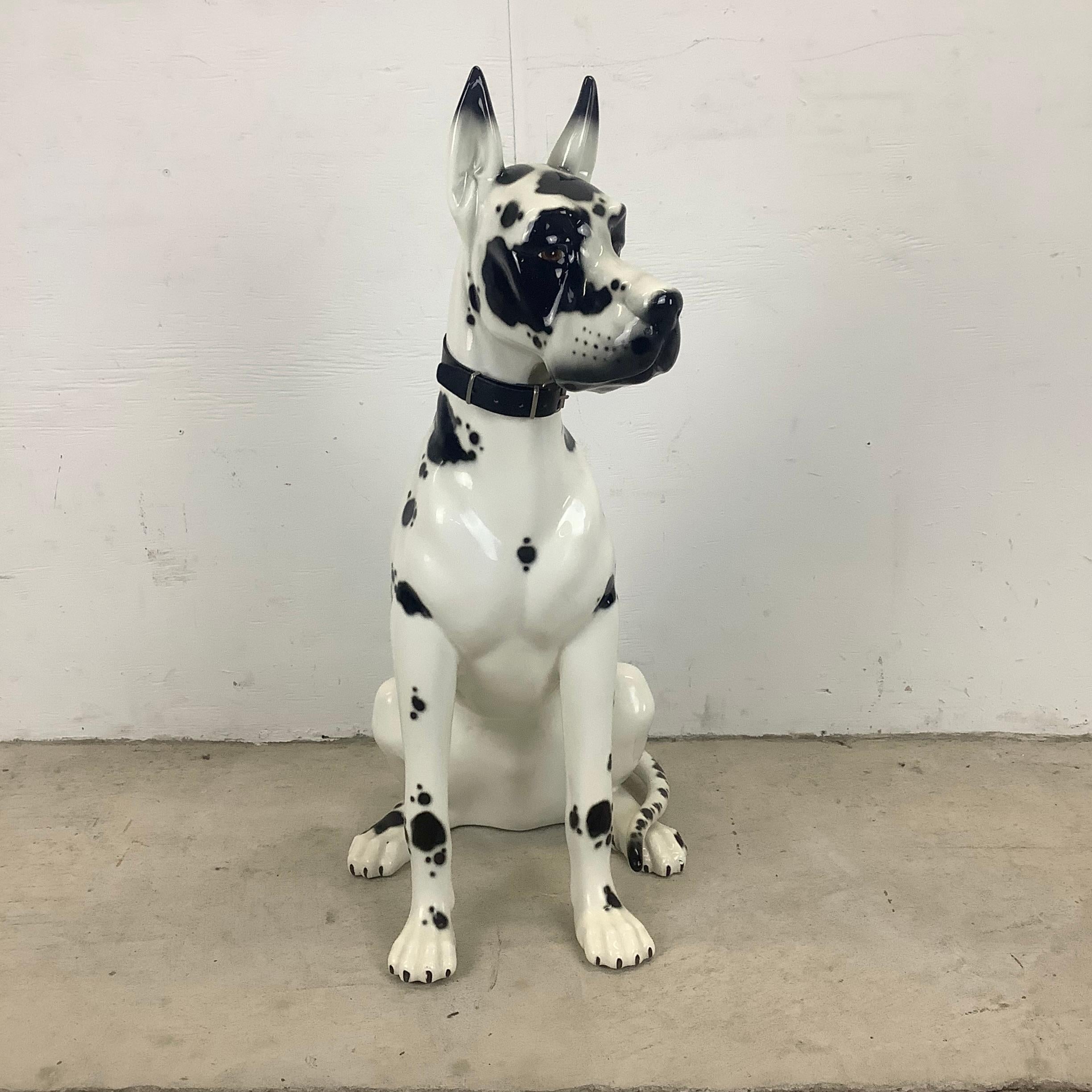This impressive vintage modern Harlequin Great Dane ceramic dog statue stands thirty-one inches tall with beautiful hand-painted coat, vinyl collar, and wonderful attention to details. This beautiful black and white spotted Great Dane dog statue