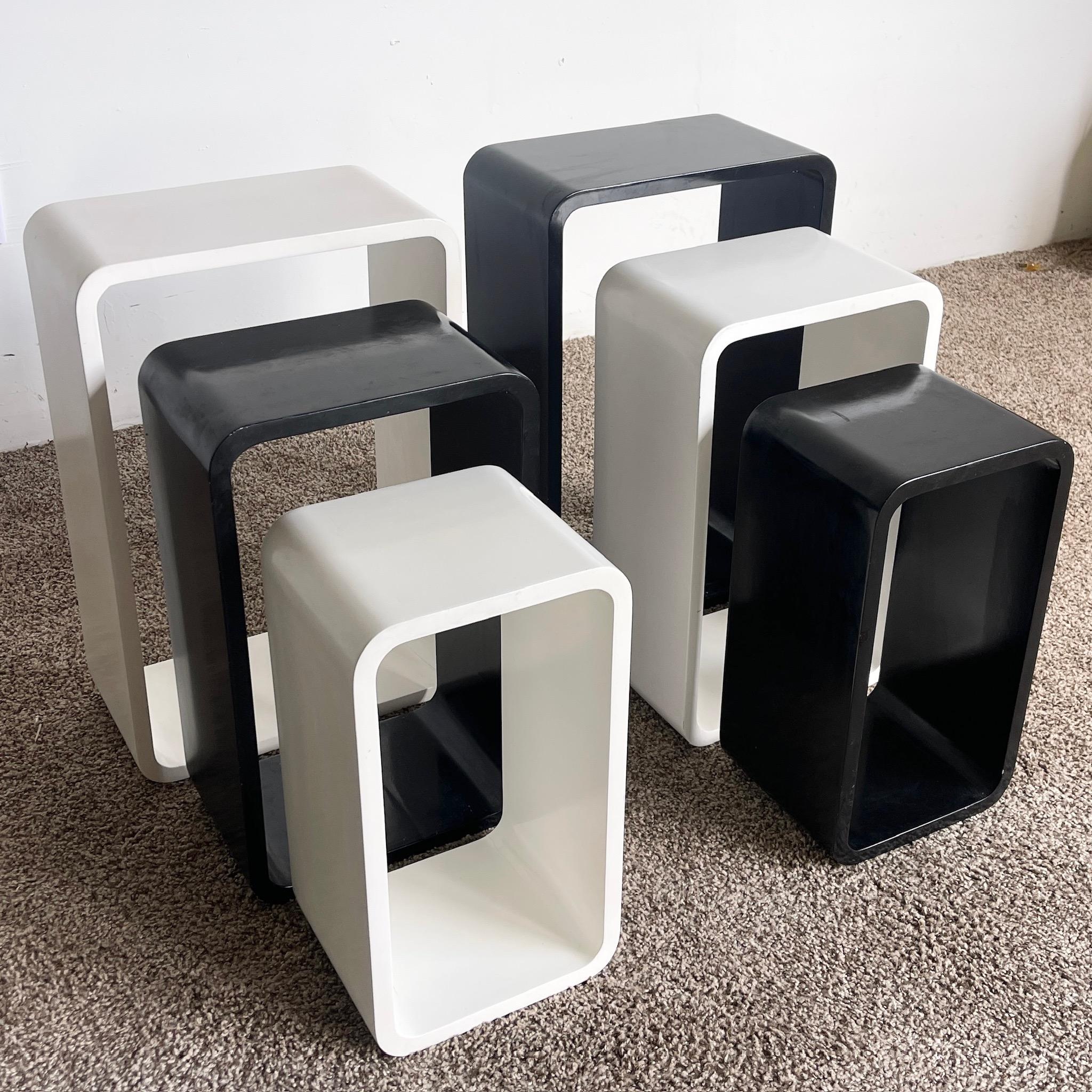 Discover the charm of these Vintage Black and White Modular Nesting Tables. This set of six tables offers versatile functionality and a striking visual appeal, perfect for any modern or mid-century inspired living space. The sleek black and white