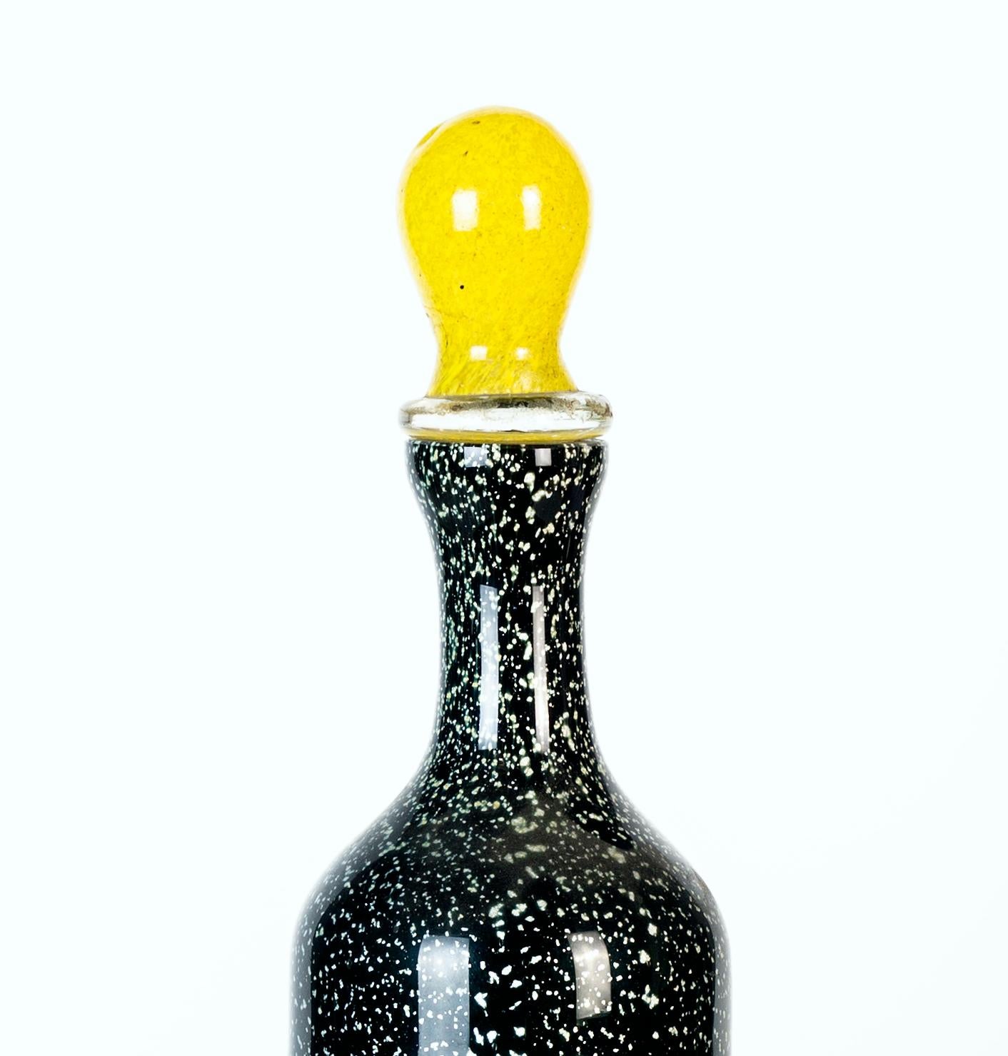Black and white spotted bottle is a beautiful glass decorative object, realized by Murano manufacture during the 1970s and designed by Jean Mell.

This decorative object is a very elegant glass black and white spotted bottle with yellow