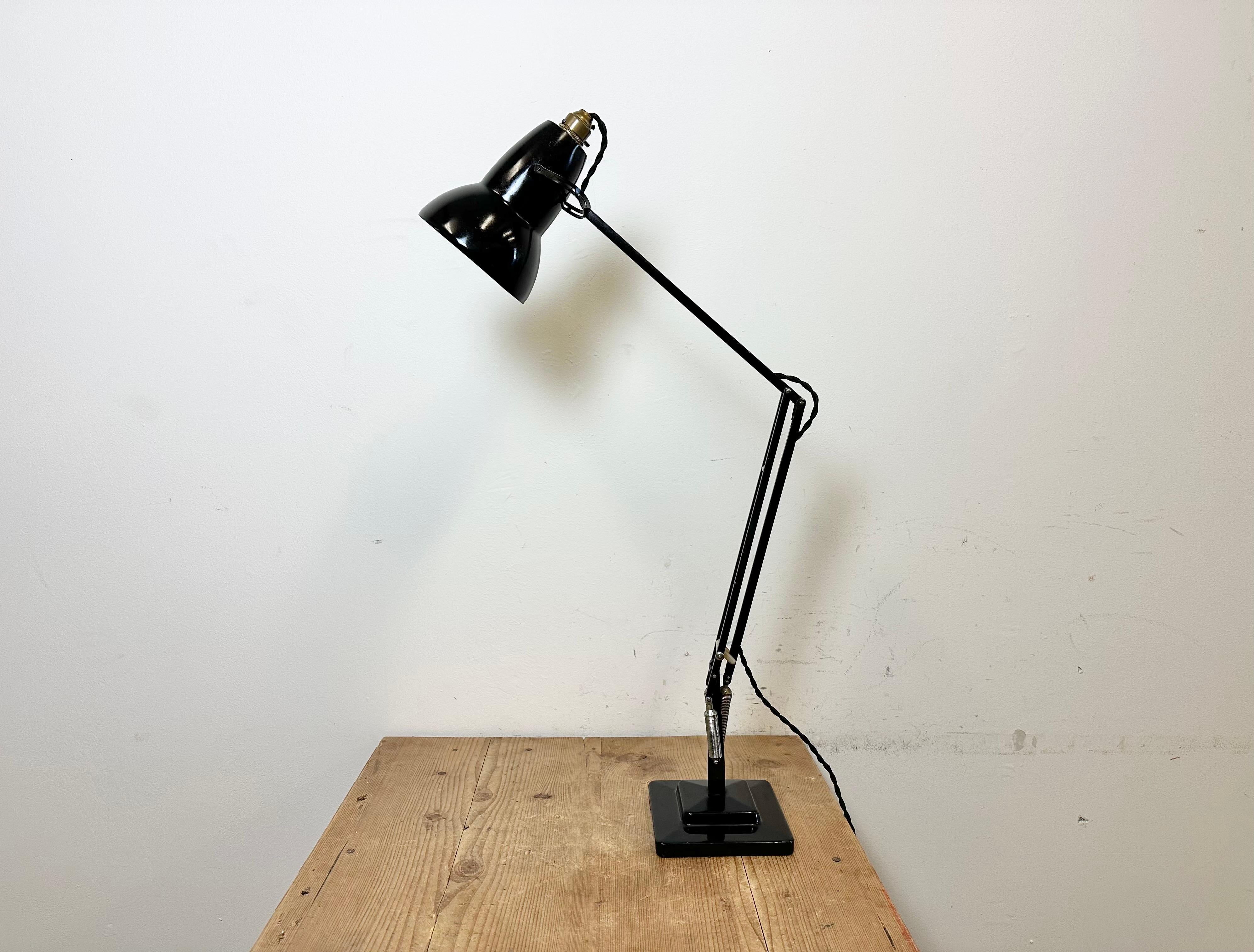 Vintage black anglepoise table lamp designed by George Carwardine and produced by Herbert Terry and Sons in United Kingdom during the 1950s. It features an iron base and arm and an aluminium shade. Original bayonet socket with switch requires