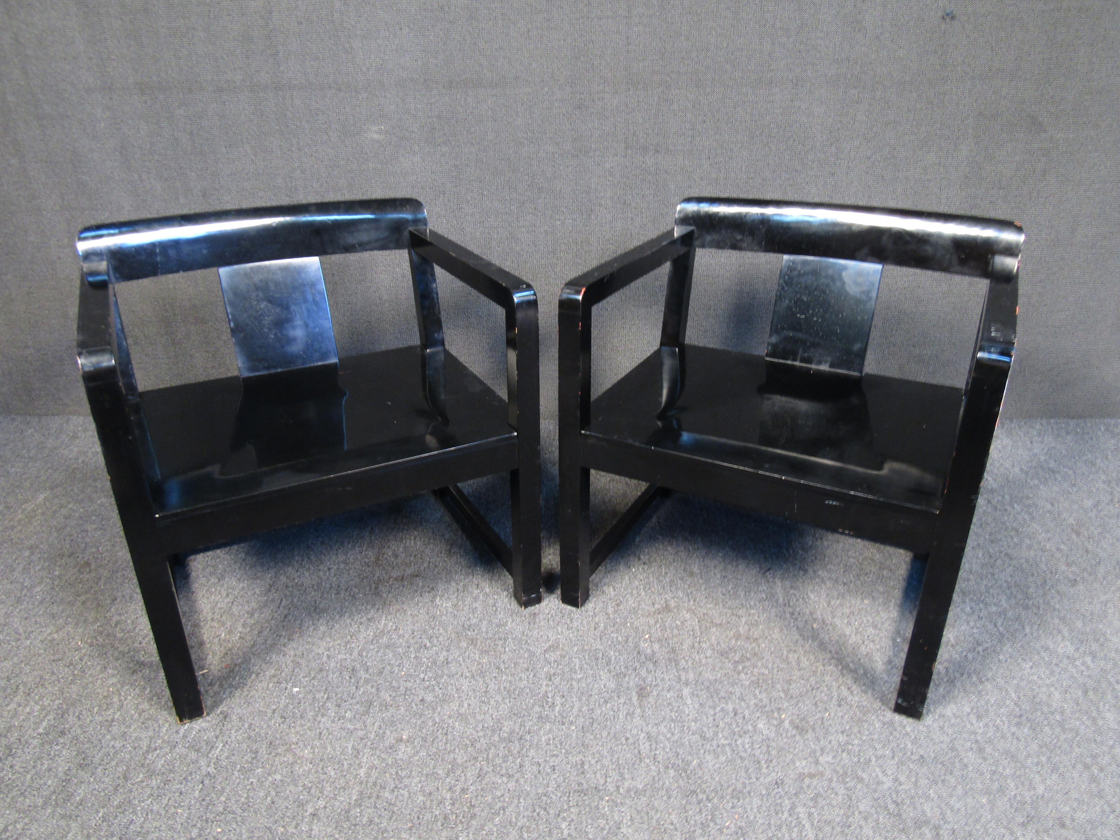 These vintage black armchairs feature a sleek black finish and are made by casamilano. This set of chairs are considered occasional or 