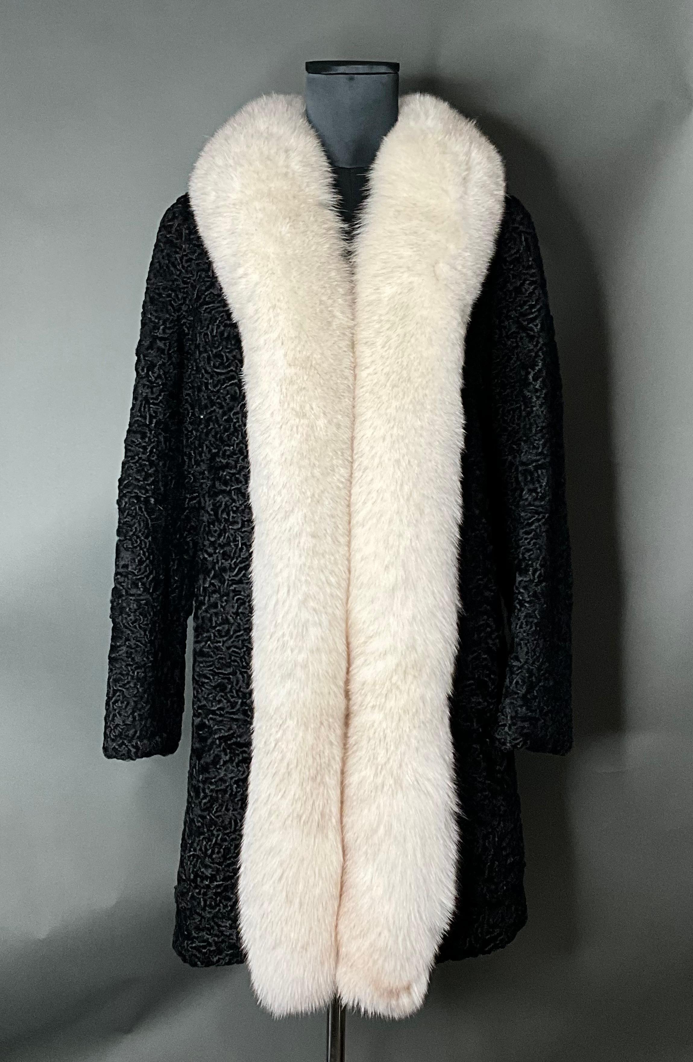 The Vintage Black Astrakhan Fur Coat with White Fox Collar is a luxurious and timeless piece that embodies the epitome of vintage glamour. Crafted from rich astrakhan fur and featuring a bold white fox collar, this coat is a statement of refinement,