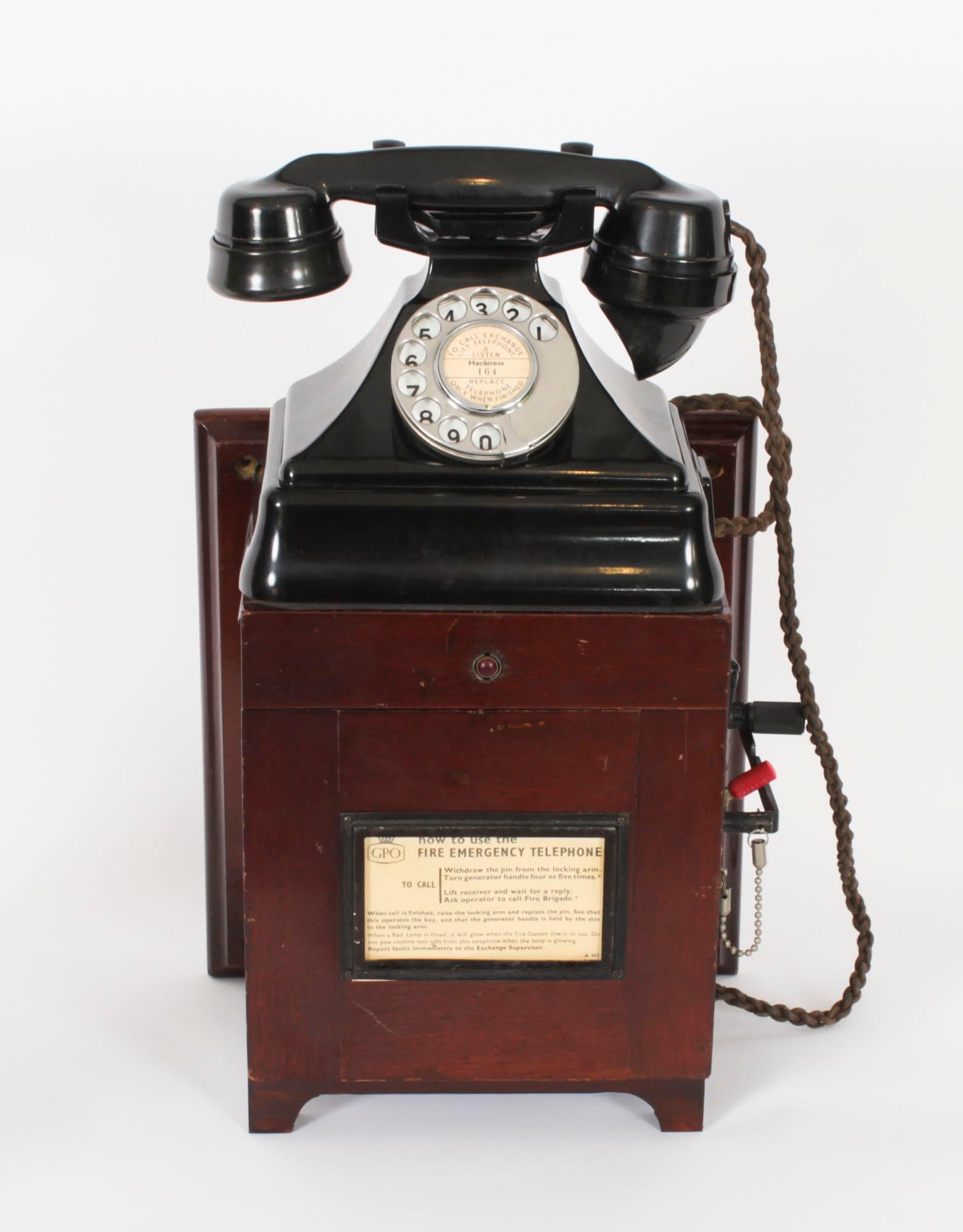 This is a rare vintage GPO desktop or wall cradle fire emergency telephone 164 in black Perspex Bakelite  together with a Dictograph system sub station, serial number 21858 circa 1940s in date.

The phone is fitted with a cased dynamo with a winding