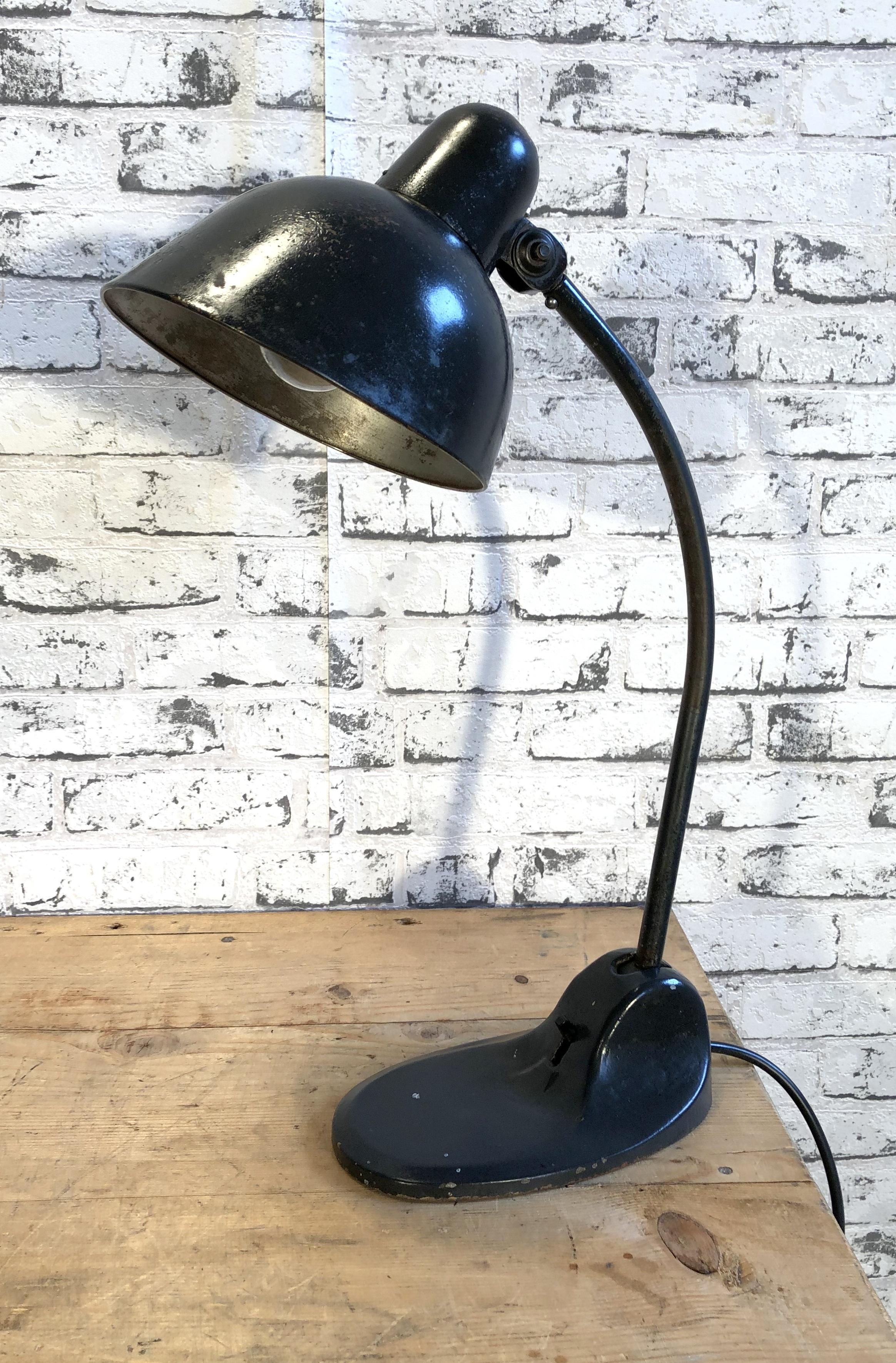 Black industrial table lamp made by Siemens during the 1930s.It features black metal shade, black iron base with original switch and arm with two adjustable joints. Original socket for E 27 lightbulbs. Fully functional.