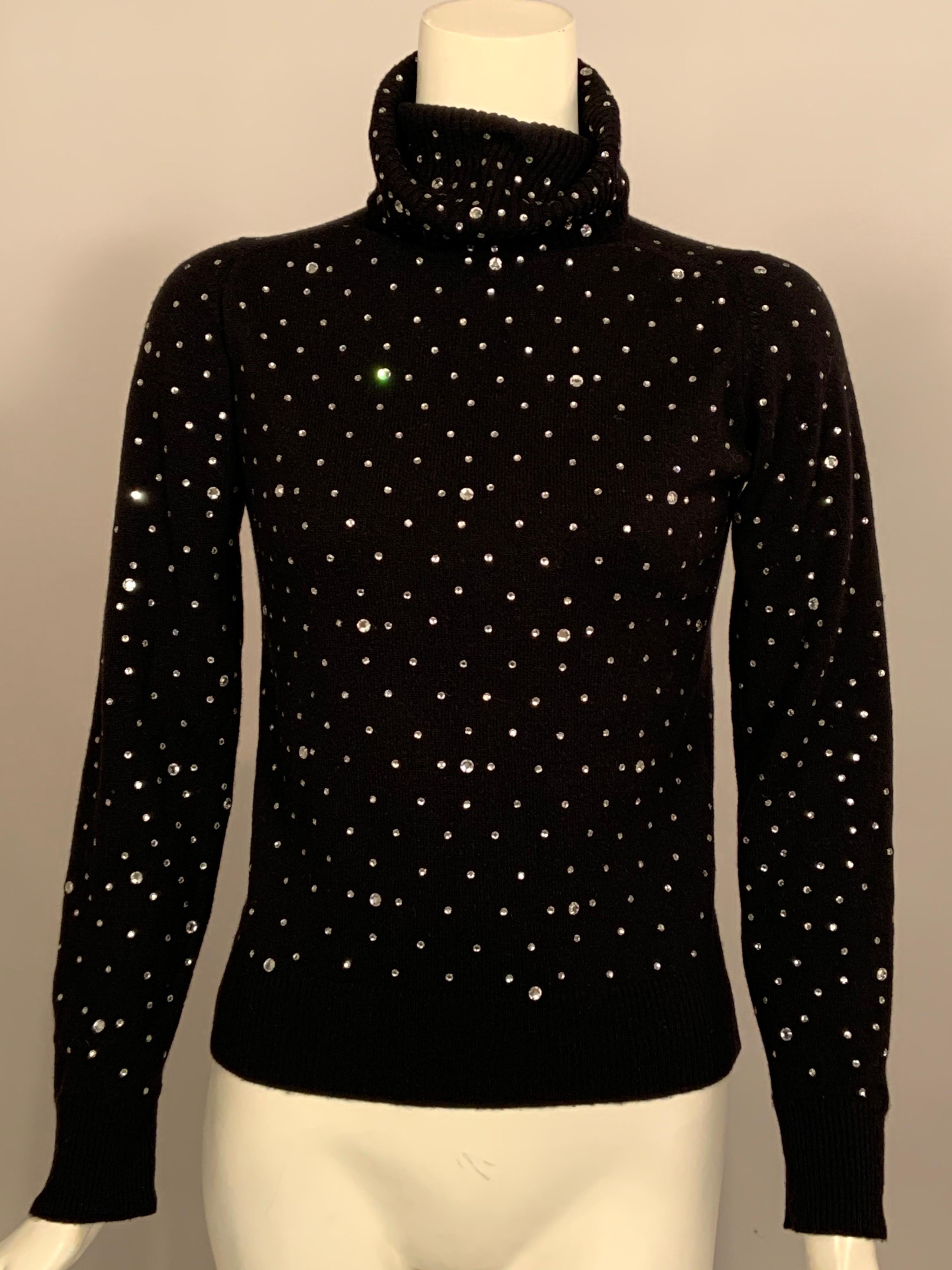 This vintage black cashmere sweater is beautifully embellished with sparkling prong set rhinestones in several different sizes. It is marked a vintage size 34 and it is in excellent condition.
Measurements;  Shoulders 14