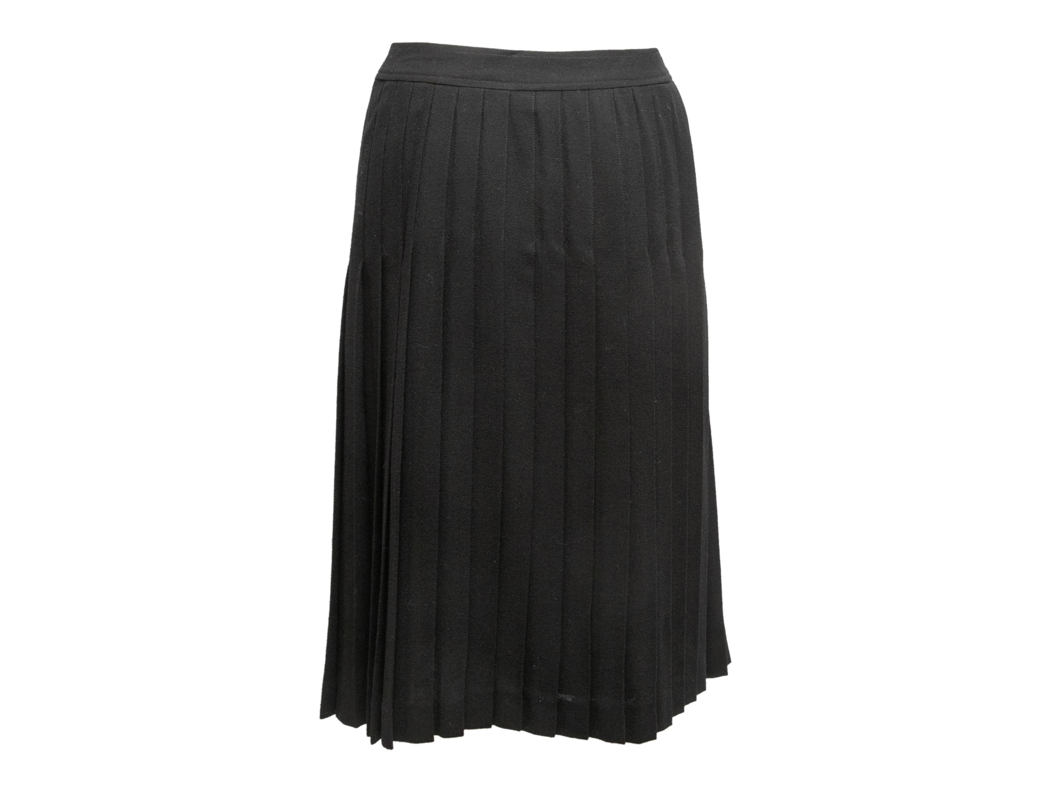 Vintage black wool pleated skirt by Celine. Button closures at side. Designer size 42. 29