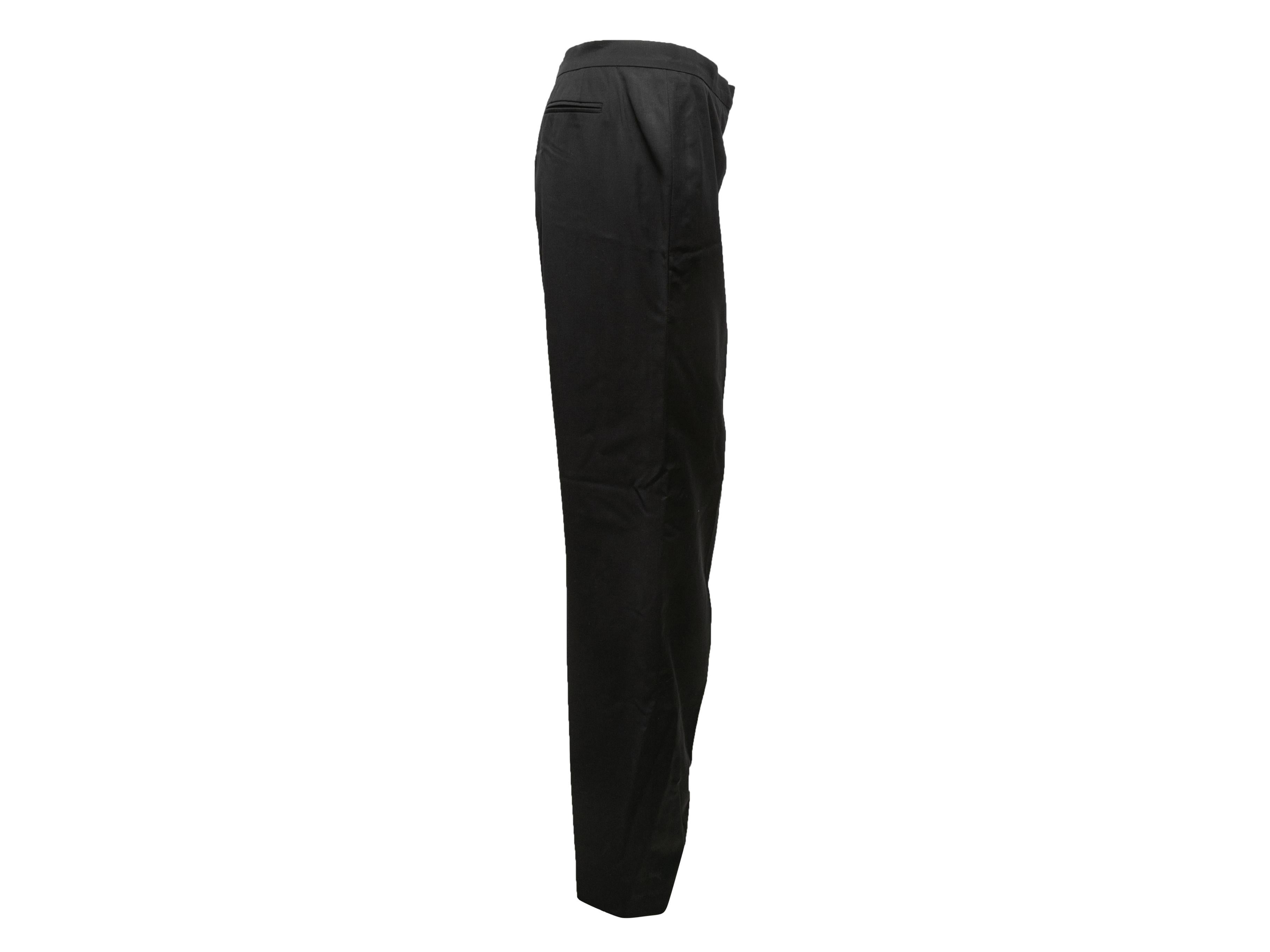 Vintage black wool trousers by Chanel Boutique. From the Spring/Summer 1997 Collection. Dual back pockets. Front zip and button closures. 38