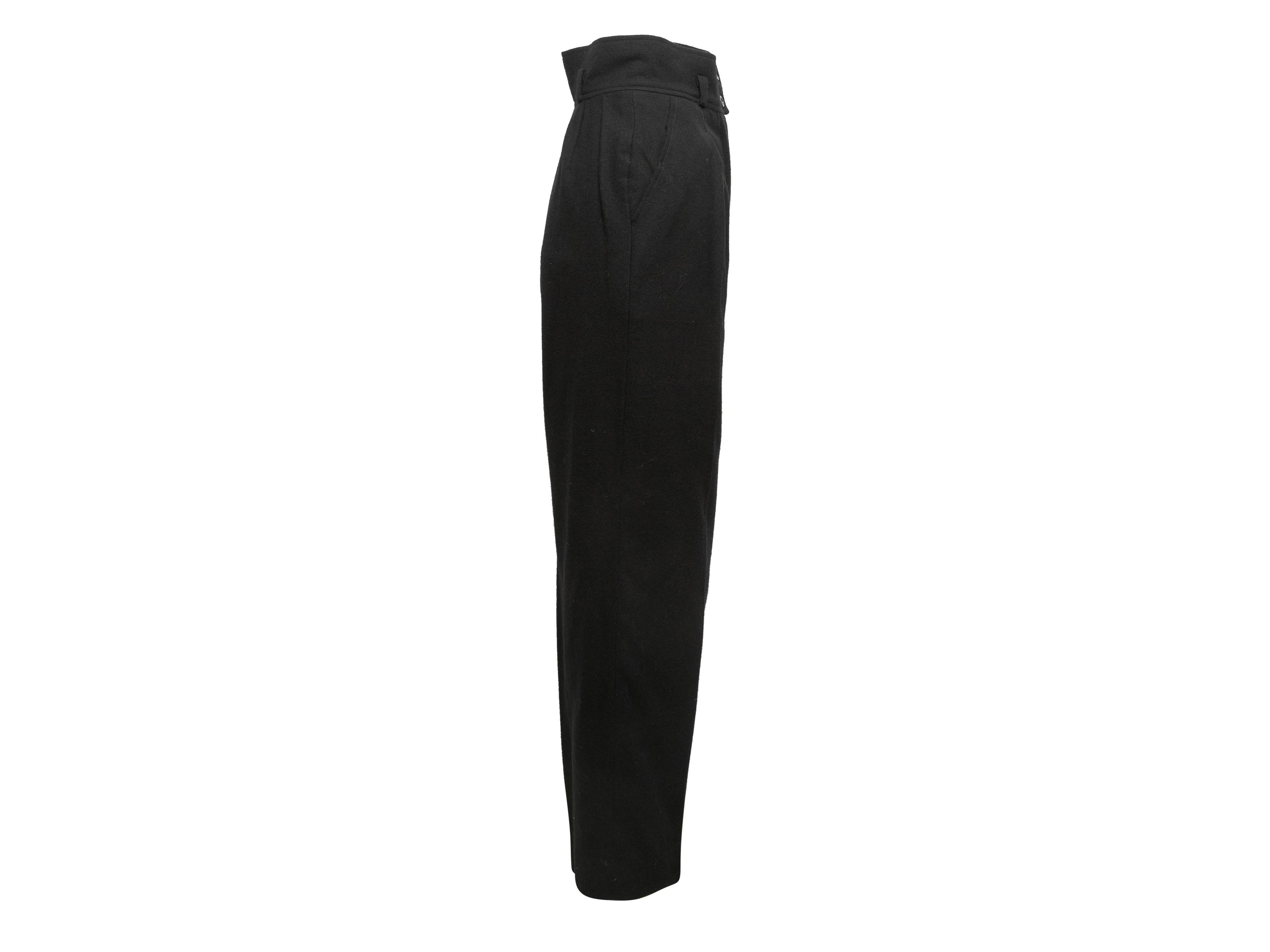 Vintage black wool straight-leg trousers by Chanel Boutique. Dual hip pockets. Zip closure at front. 23