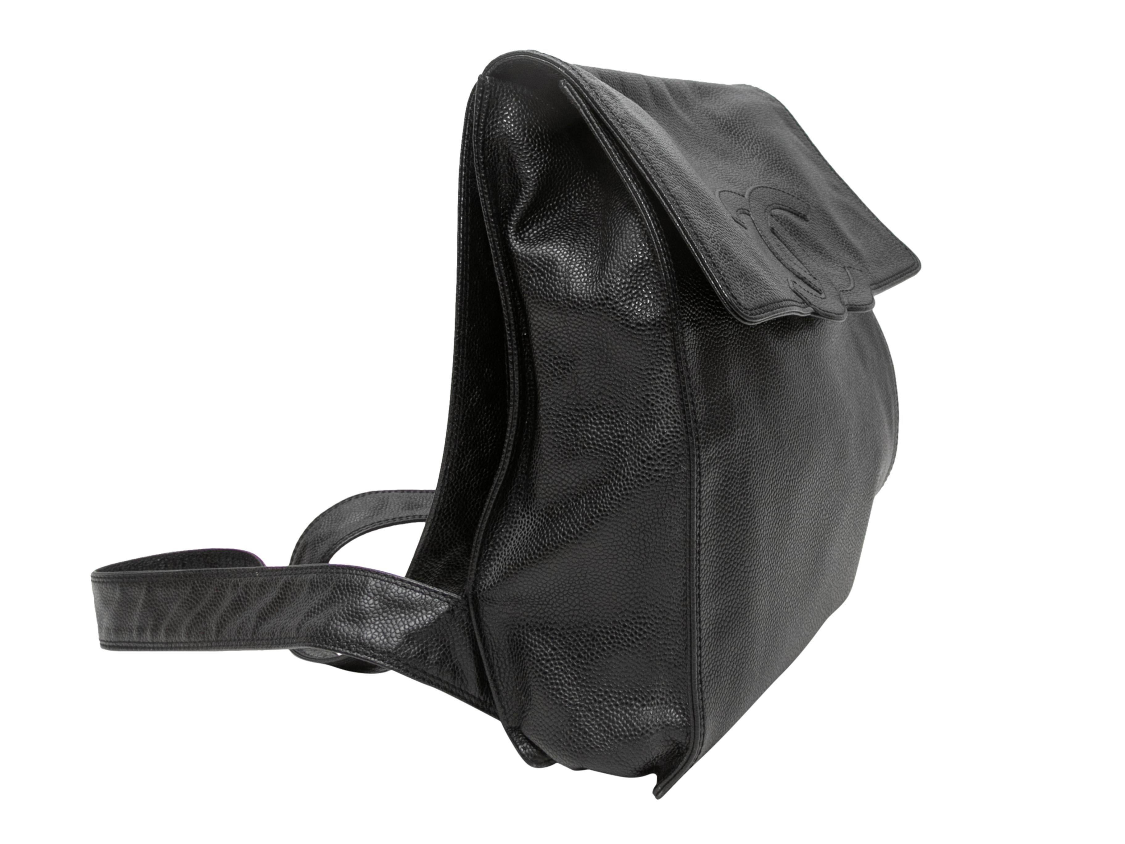 Product Details: Vintage Black Chanel Caviar Leather CC Backpack. This backpack features a caviar leather body, gold-tone hardware, dual flat shoulder straps, and a top flap closure. 10