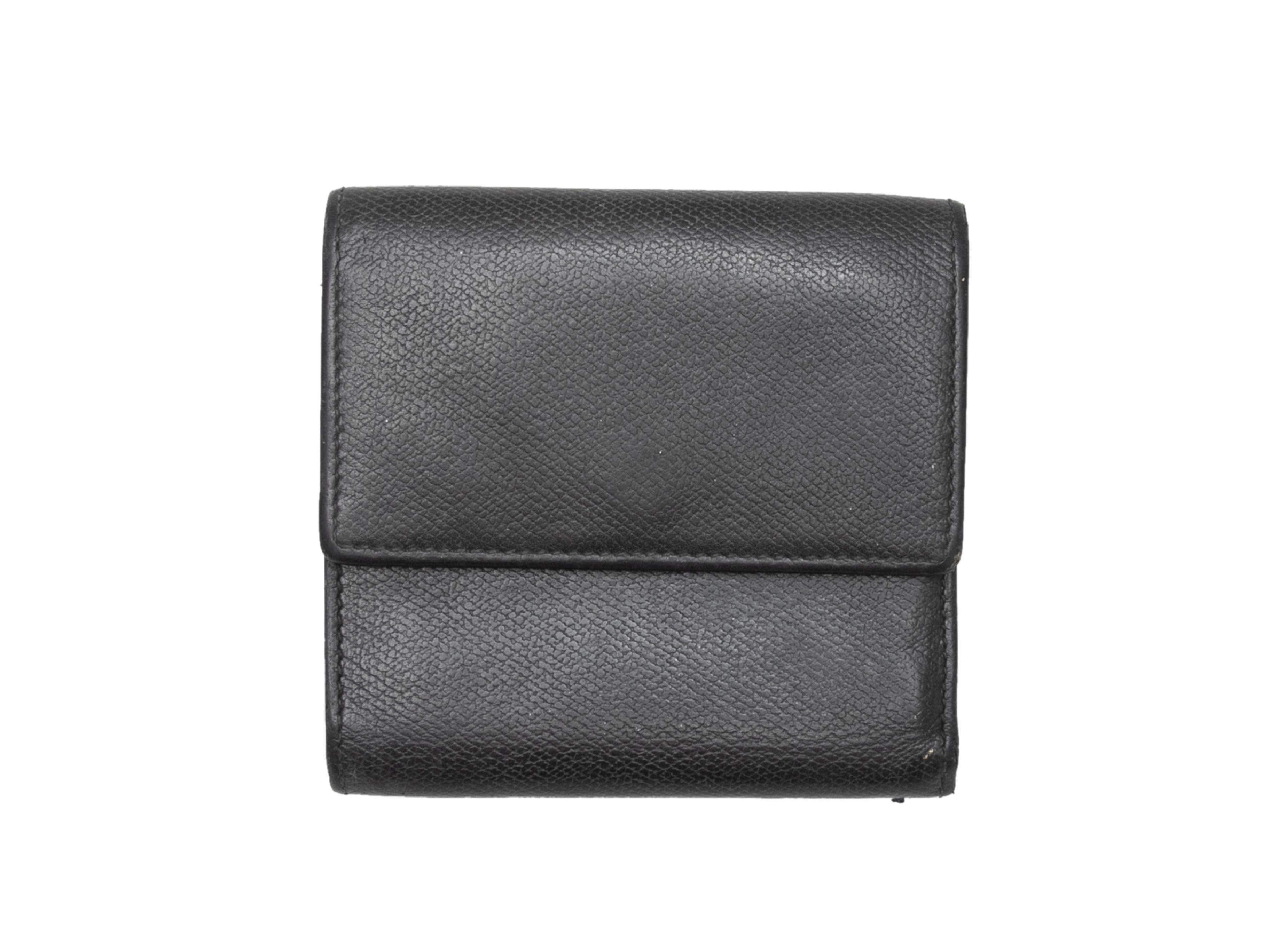 Vintage black leather wallet by Chanel. Multiple interior card and cash slots. Front snap closure. 4