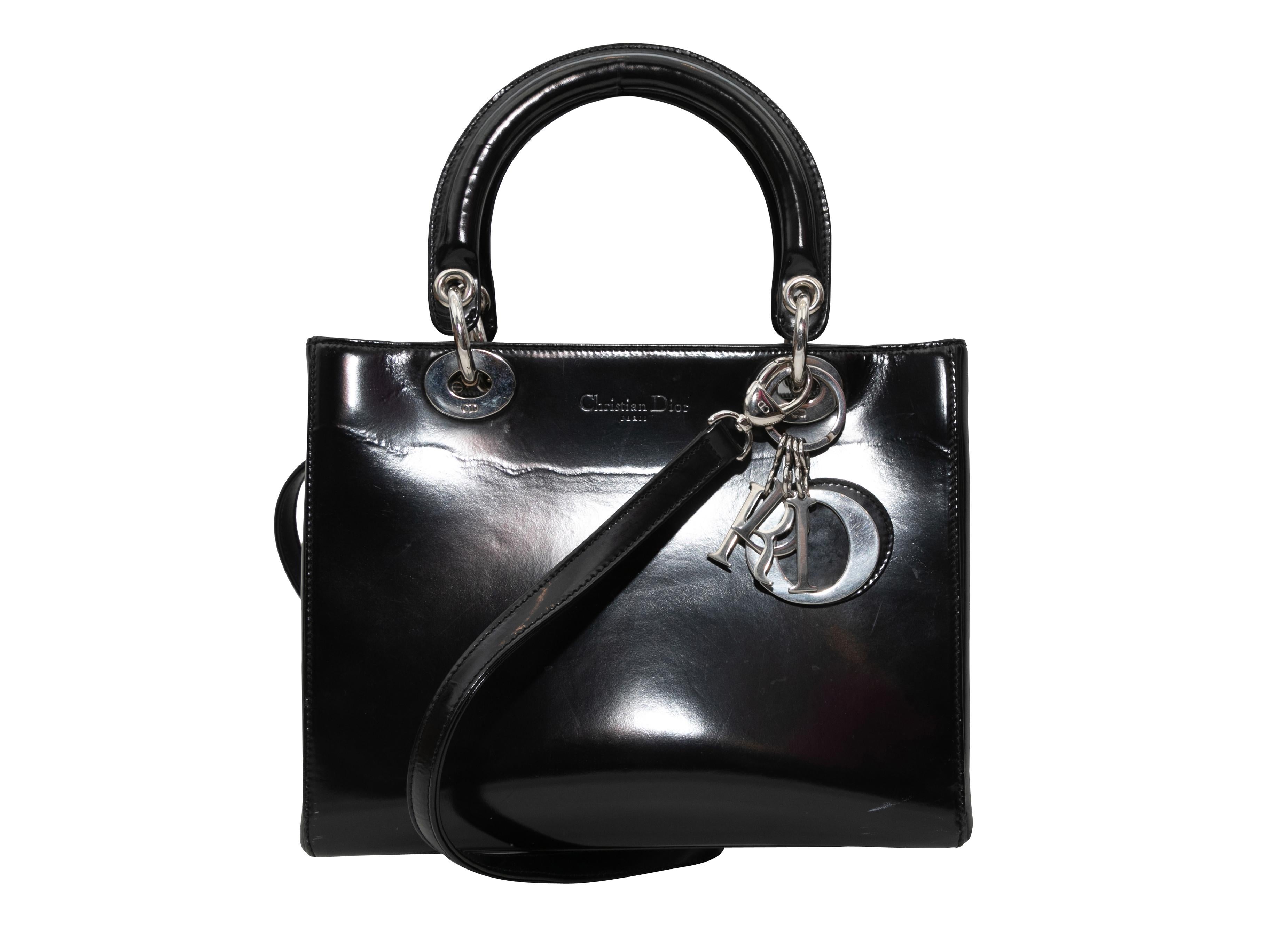 Product Details: Vintage Black Christian Dior Medium Patent Lady Dior Bag. The Medium Patent Lady Dior Bag features a patent leather body, silver-tone hardware, duel top handles, and an optional flat shoulder strap. 9.5