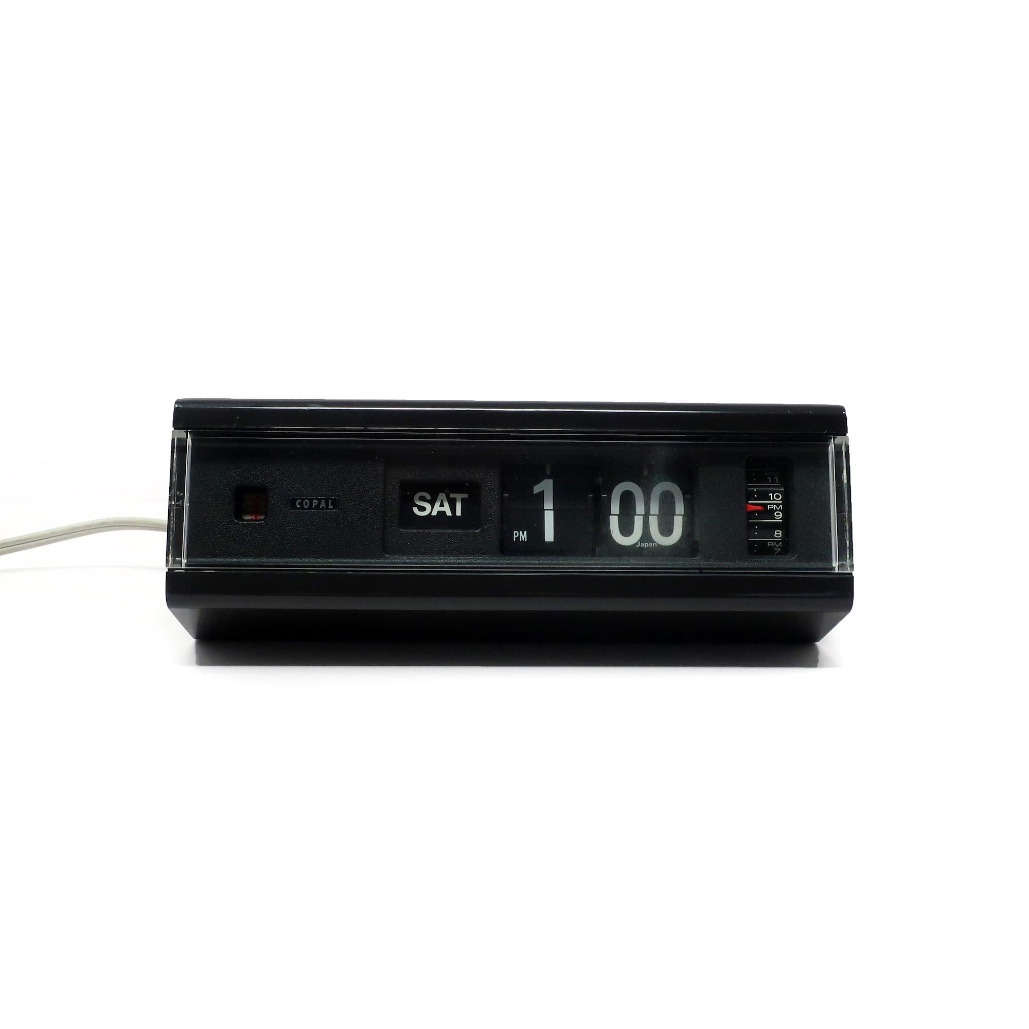 A beautiful mid-century modern Copal Model 229 flip clock with black plastic case, black face, white numbers and clear plastic front.  Minutes and hours flip as time passes, providing a satisfying quiet sound.  Looks fantastic and works great!  Has