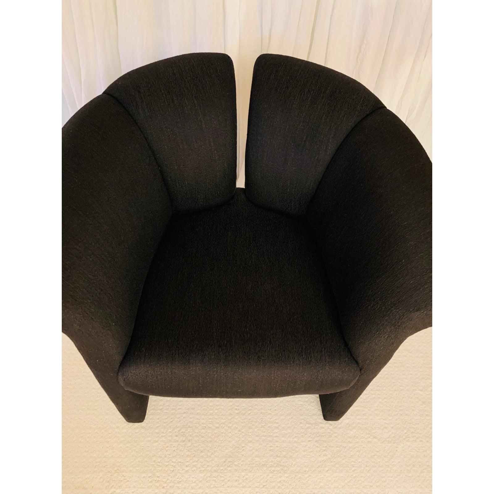 This curvaceous chair is in truly perfect condition.
The black upholstery is rich, not faded at all.
While the silhouette is a bit more formal than your every-day boxy club, it remains quite comfortable.