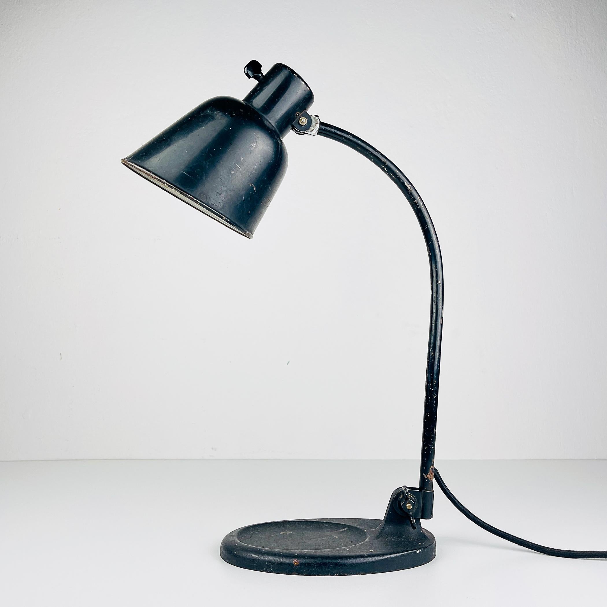 Introducing the exceptional industrial desk lamp designed by Christian Dell, the iconic Model 2768 Matador Bur produced by the esteemed Bauhaus in the 1930s. This lamp stands as a vibrant symbol of the Bauhaus movement, embodying its principles of