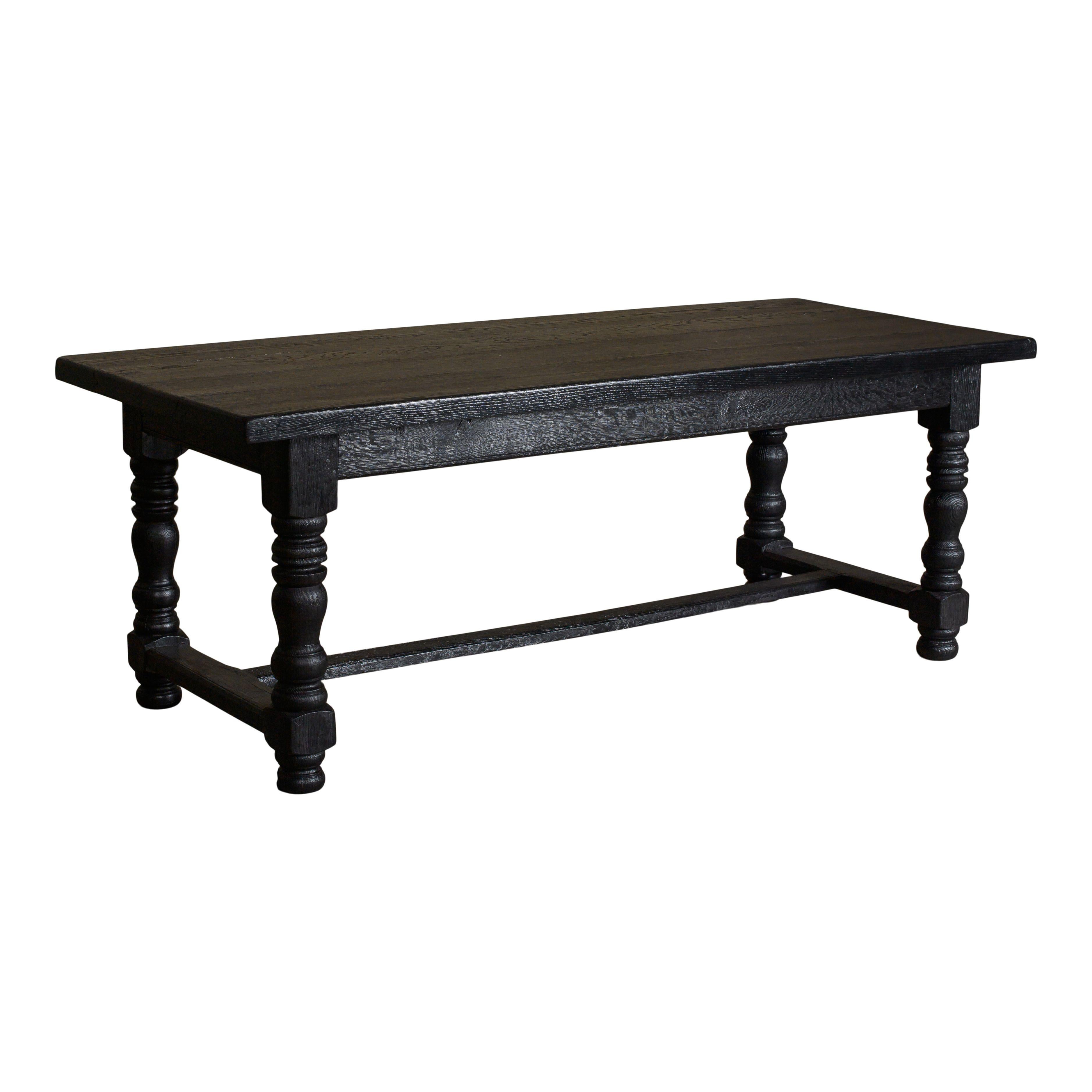 A beautiful vintage wood dining table from Belgium. This classic vintage table features beautiful spindle legs that give it a simple and timeless look. The legs are connected on the sides and with a middle beam (12.75