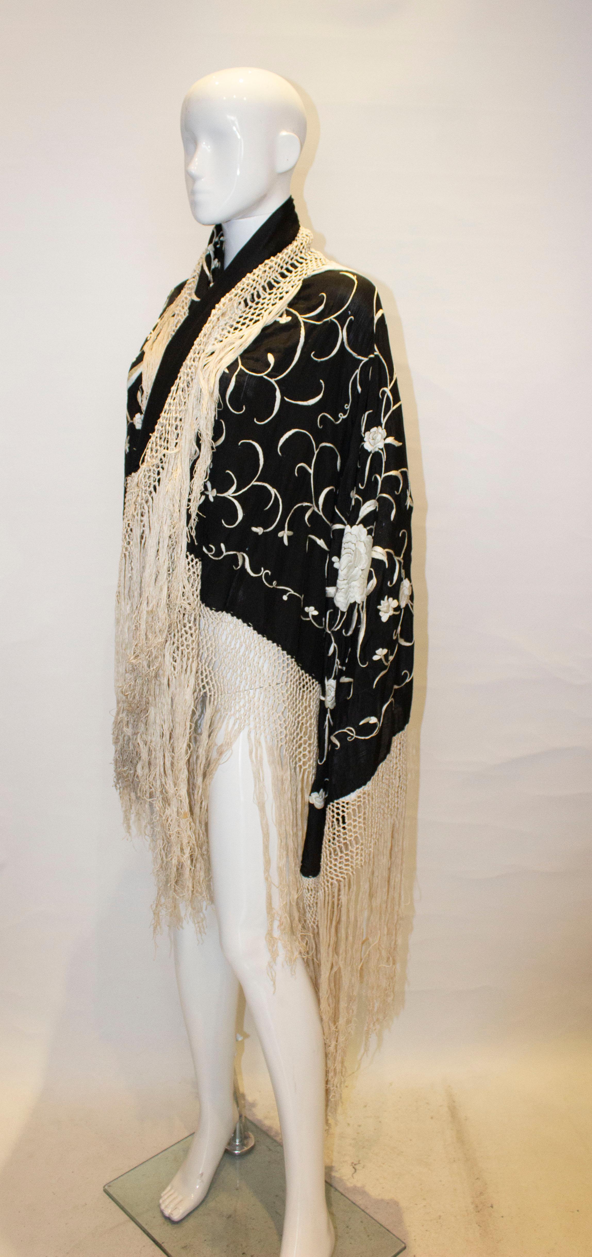 A wonderful vintage black silk piano shawl with wonderful floral embroidery and fringing.
Measurements: black shawl 50''x 50'', weaving is 3 1/2'' deep and the fringing is 16''.