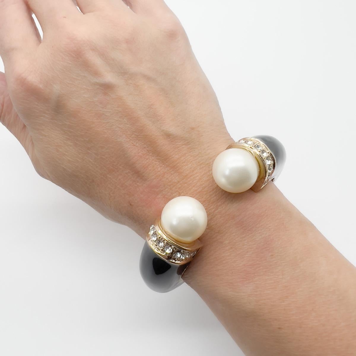 A stunning Vintage Enamel Pearl Torque Cuff. Timeless drama with this bold and beautiful cuff. The perfect final adornment.

An unsigned beauty. A rare treasure. Just because a jewel doesn’t carry a designer name, doesn’t mean it isn't coveted. The