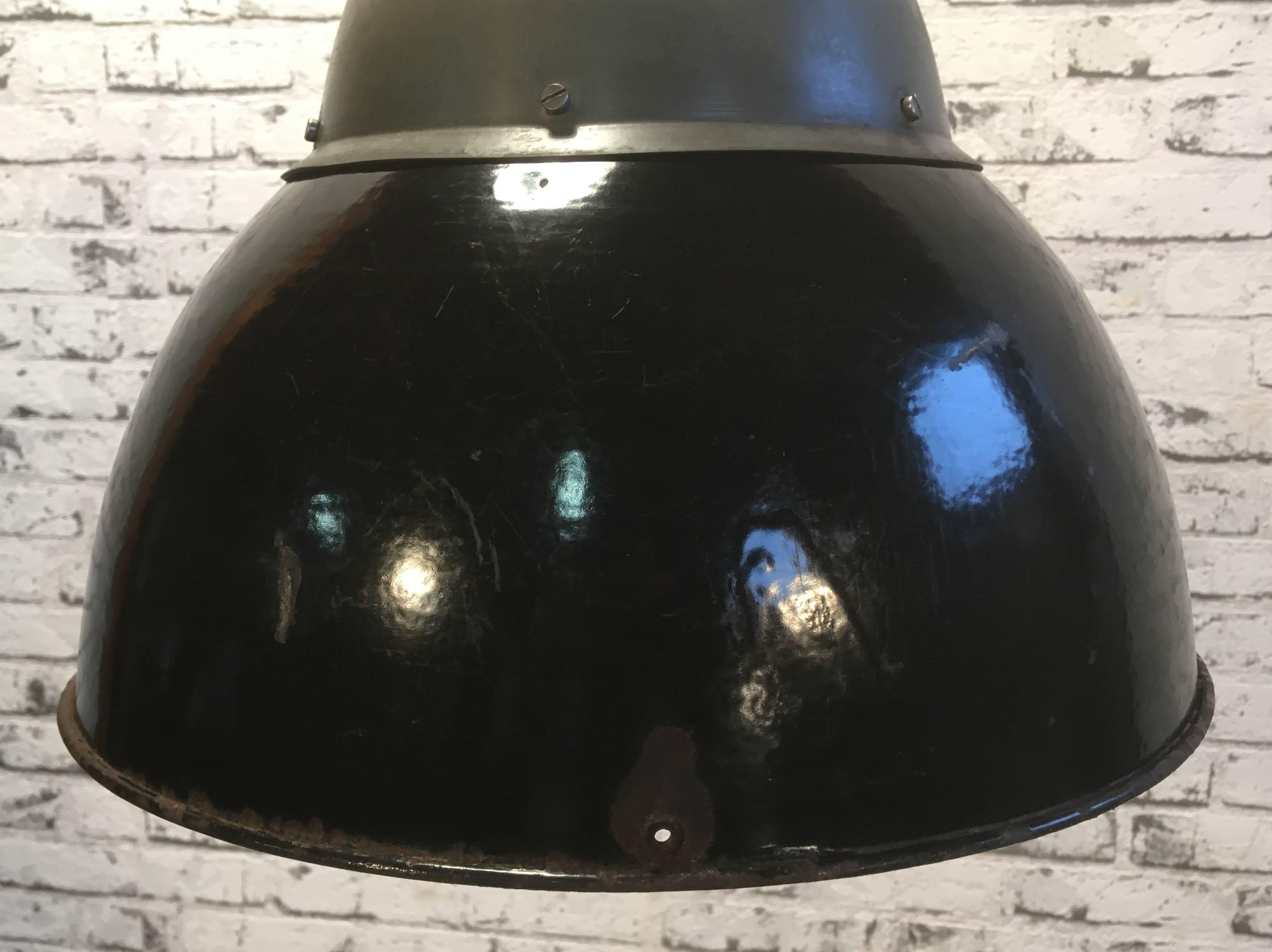 Vintage industrial hanging lamp  from former Czechoslovakia ,made during the 1930s.
Lamp has iron dome and black enamel lampshade. White interior. Beautiful patina.
New porcelain socket for E27 lightbulbs. New wire. Fully functional.
Weight: 2.5 kg. 