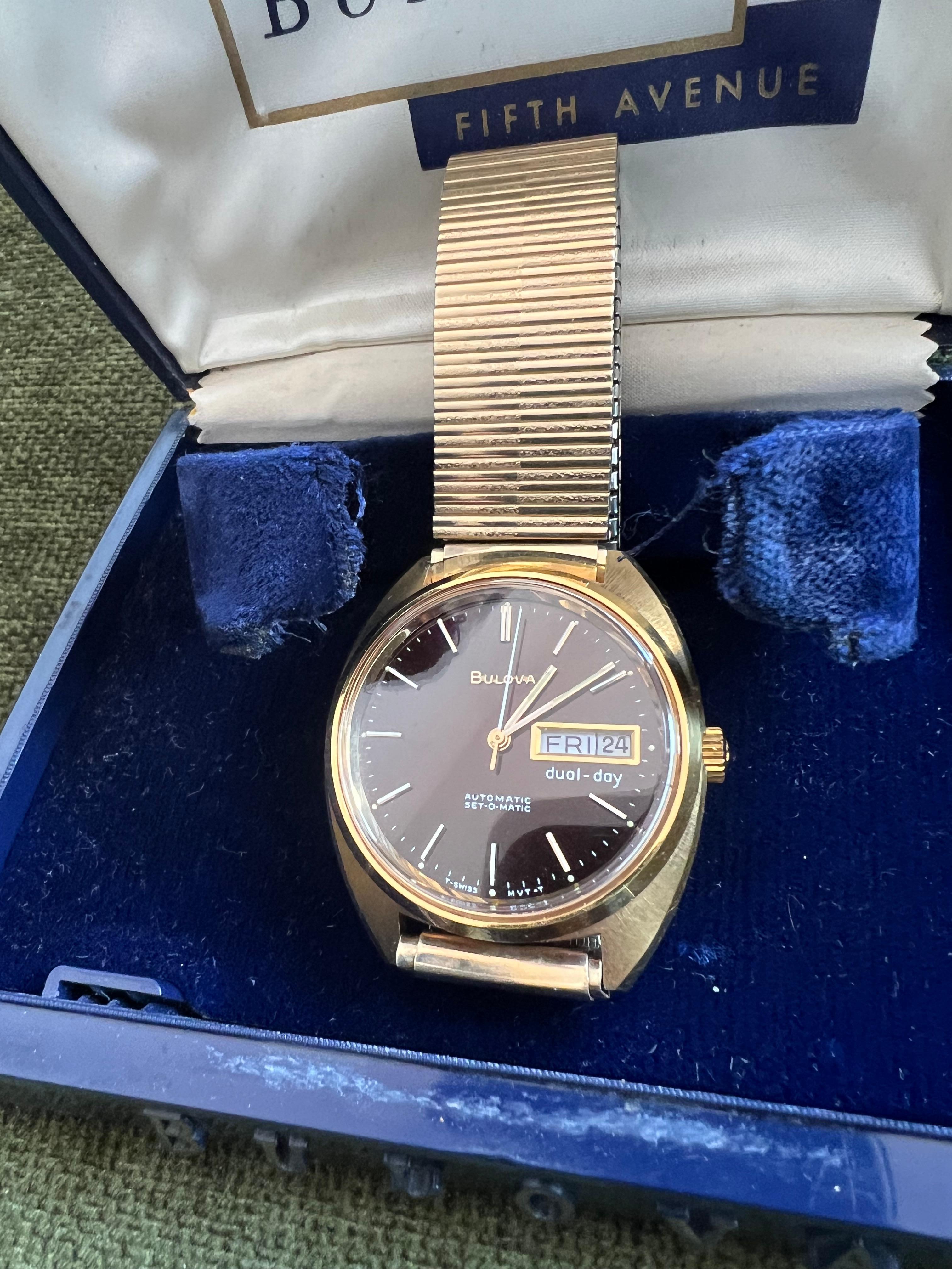 Vintage Black Face Bulova Stainless Steel Gold Tone In Original Fifth Ave Case 

Circa 1970

Vintage Bulova, a beautiful men's timepiece that is powered by quartz (battery) movement which is cased in a yellow gold case. It has a round shape face,