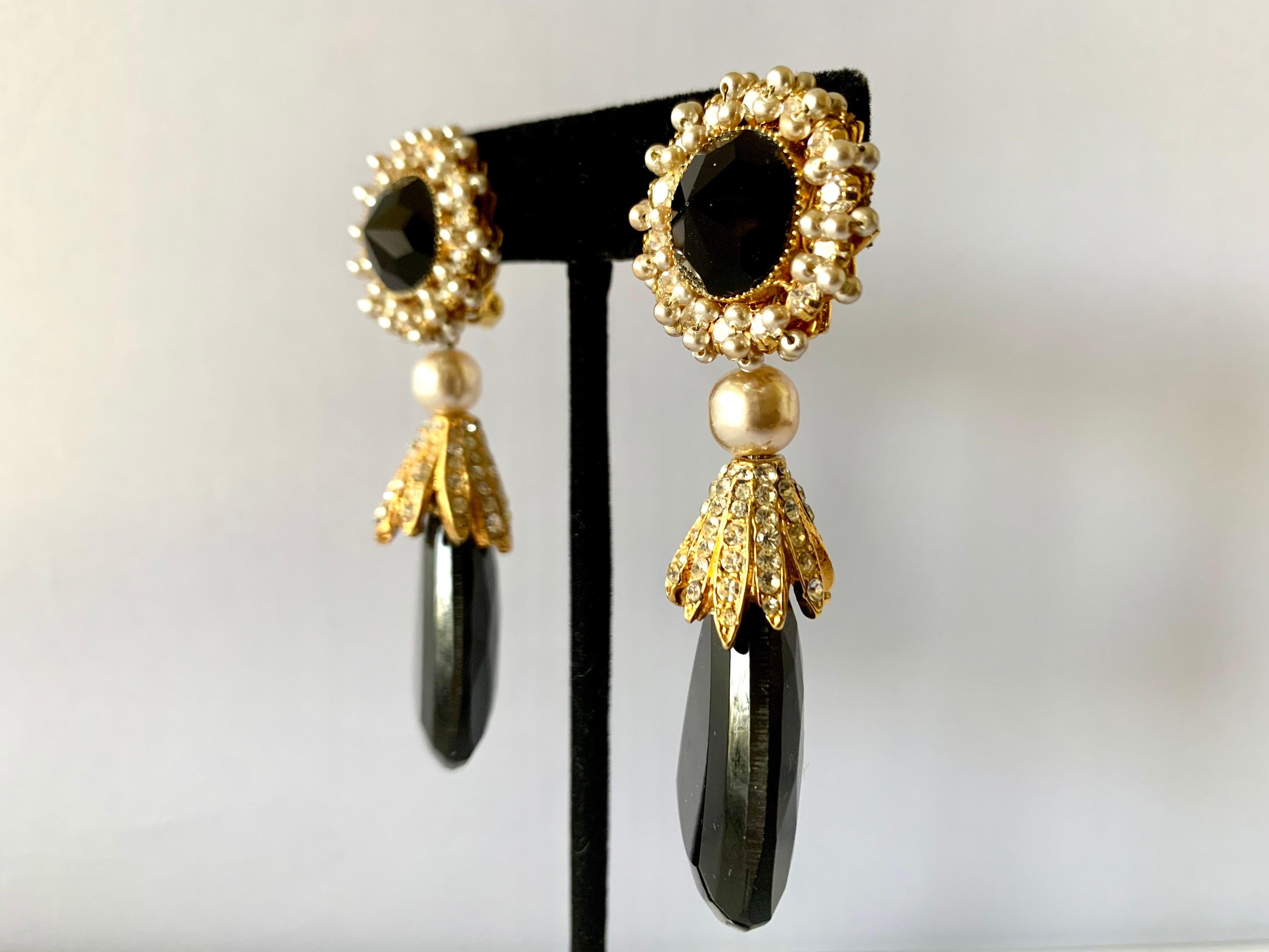 Vintage earrings by William de Lillo - comprised out of gilt metal, intricately beaded with pearls and accented by rhinestones and large faceted glass beads. Signed de Lillo, circa 1970s.
