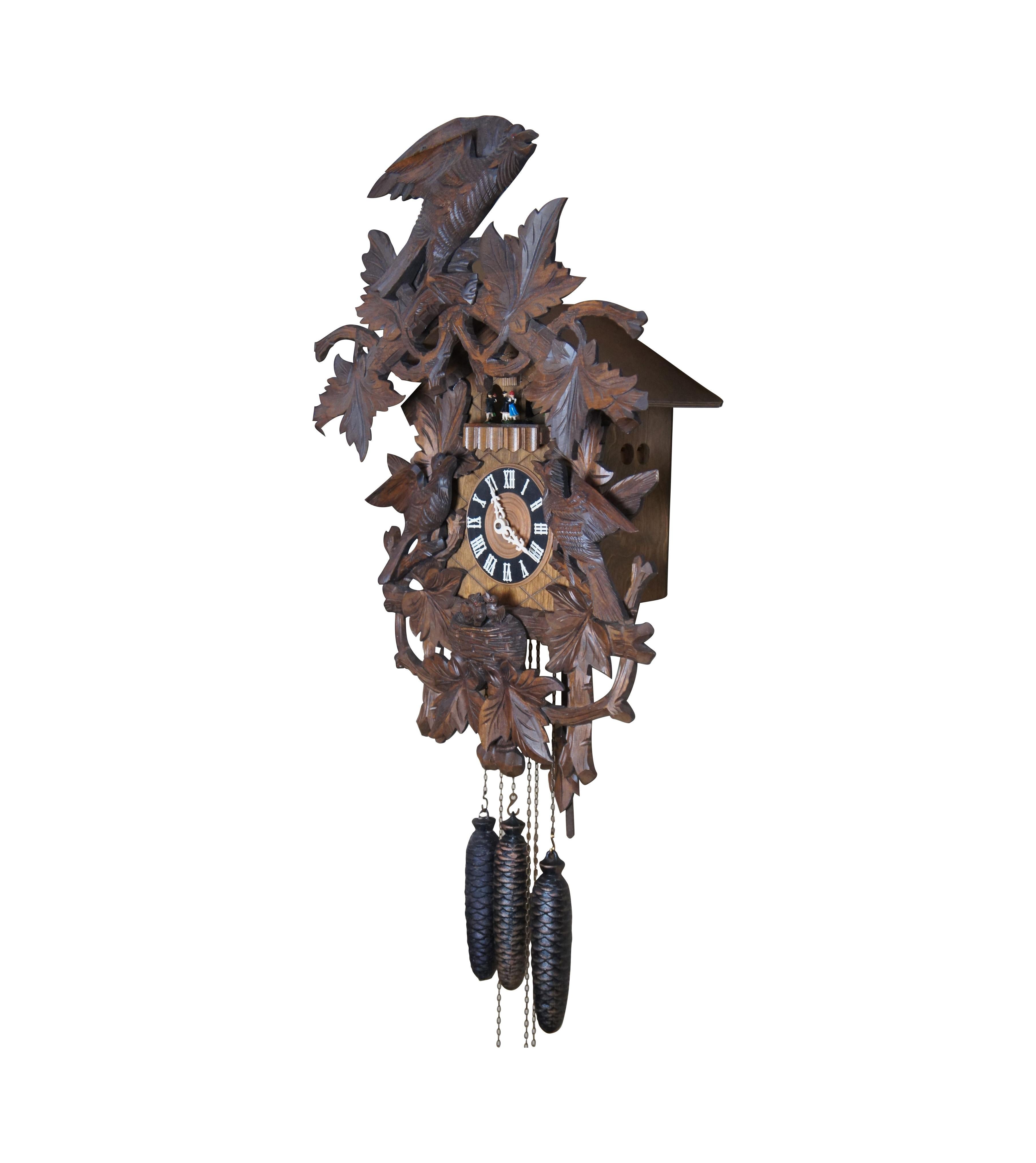 A large vintage black forest cuckoo wall clock, made in Germany. Features Regula-72 German 8 day movement with Cuendet Swiss musical movement playing Lara's Theme from Dr. Zhivago. The Roman numeral clock face has a lattice backing and is surrounded
