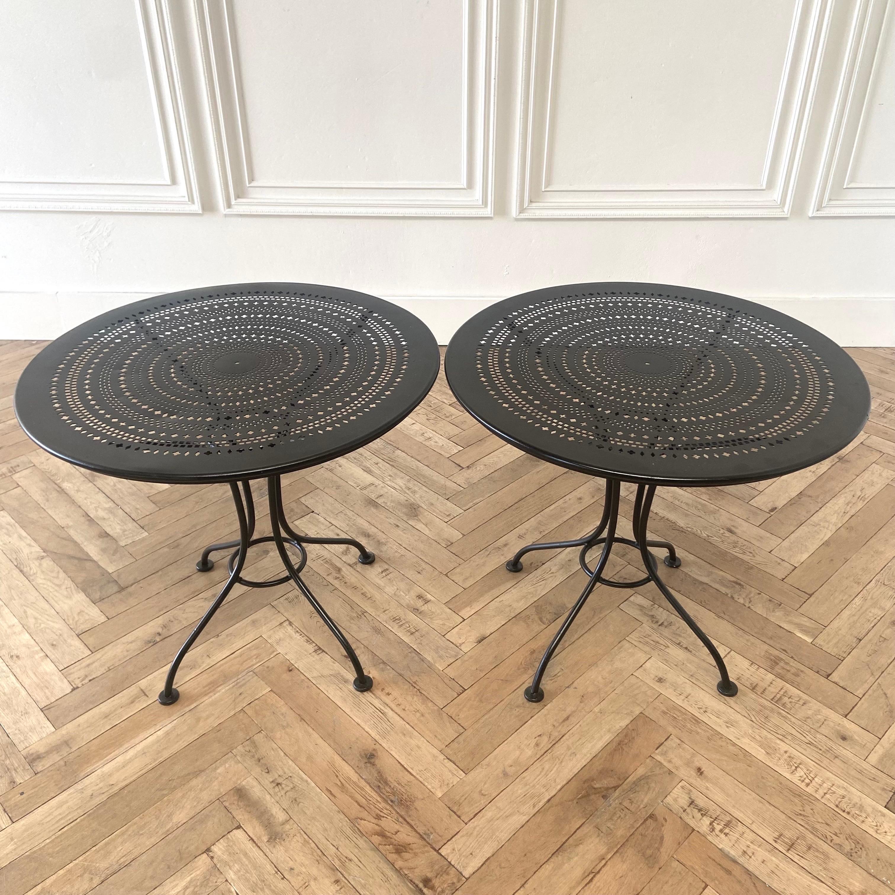 Sold individually, these French Metal and Iron tables have newer black painted finish. Remnants of original paint still showing through, ready to use. Solid and sturdy. 
Size: 31”rd. X 28”h.